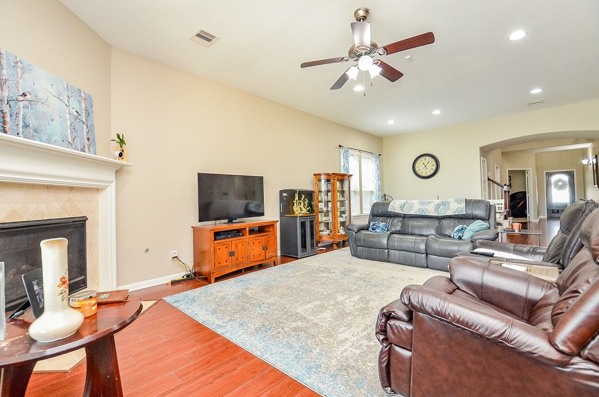 The living room has a cozy corner fireplace and most of the home has smart lighting.
