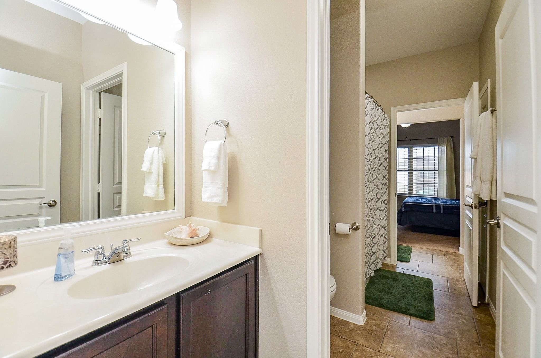 The upstairs bathroom connects one of the bedrooms to the hallways and has two separate sink areas for maximum convenience.