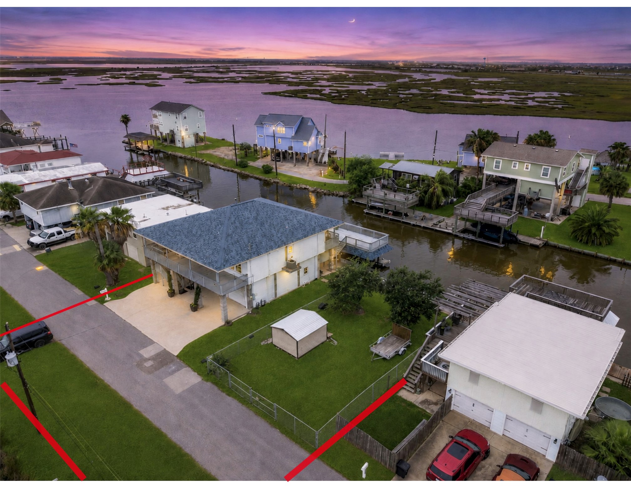 The property includes both Lots 112 and 113, creating an exceptional double-lot homesite totaling more than 11,000 sq. ft. The additional fenced lot extends across the street, providing valuable outdoor space rarely available with a Bayou Vista waterfront home.
