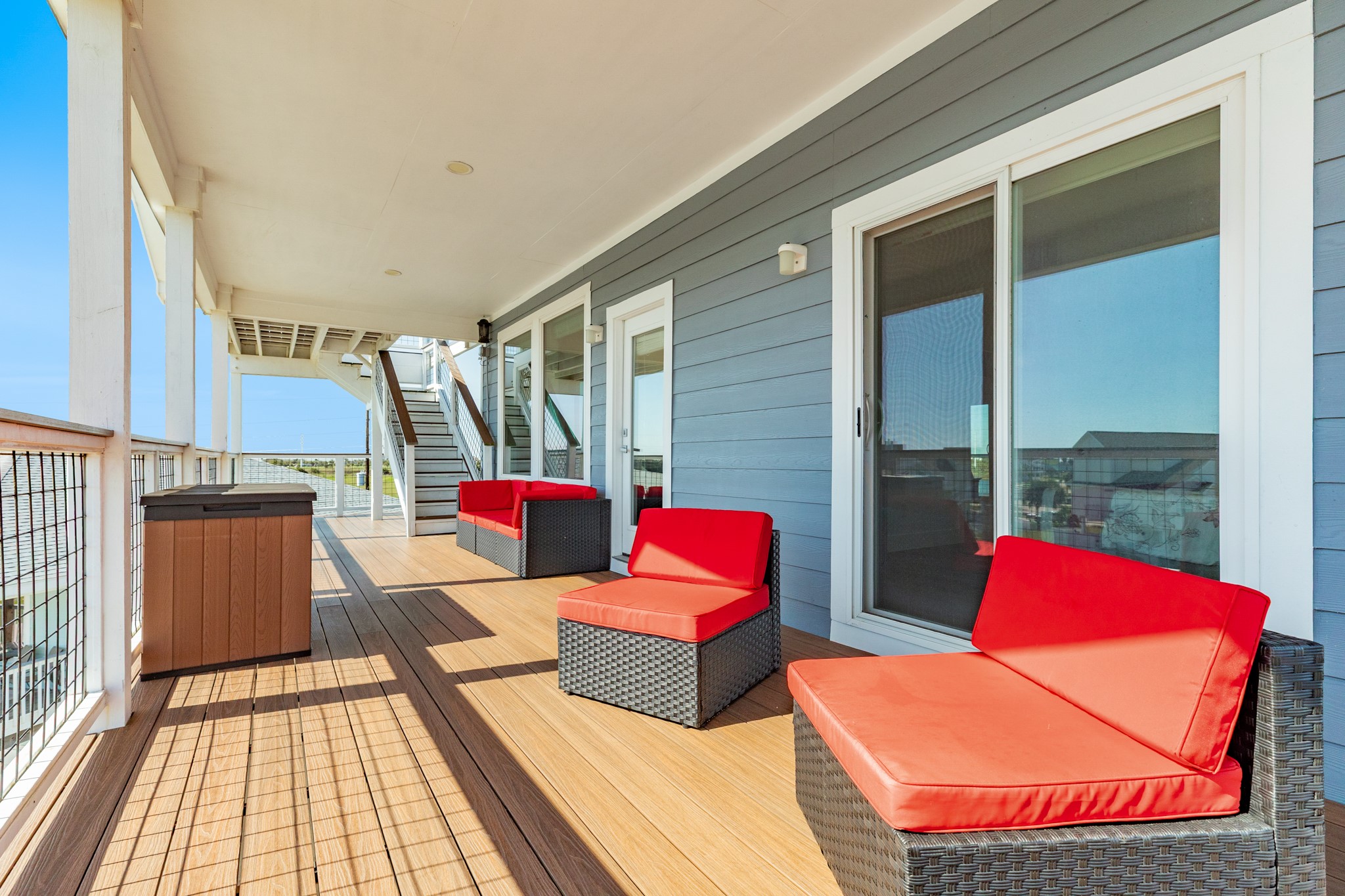 South facing 2nd level covered deck area with staircase leading up to observation platform. Deck access is from the family room or primary bedroom.