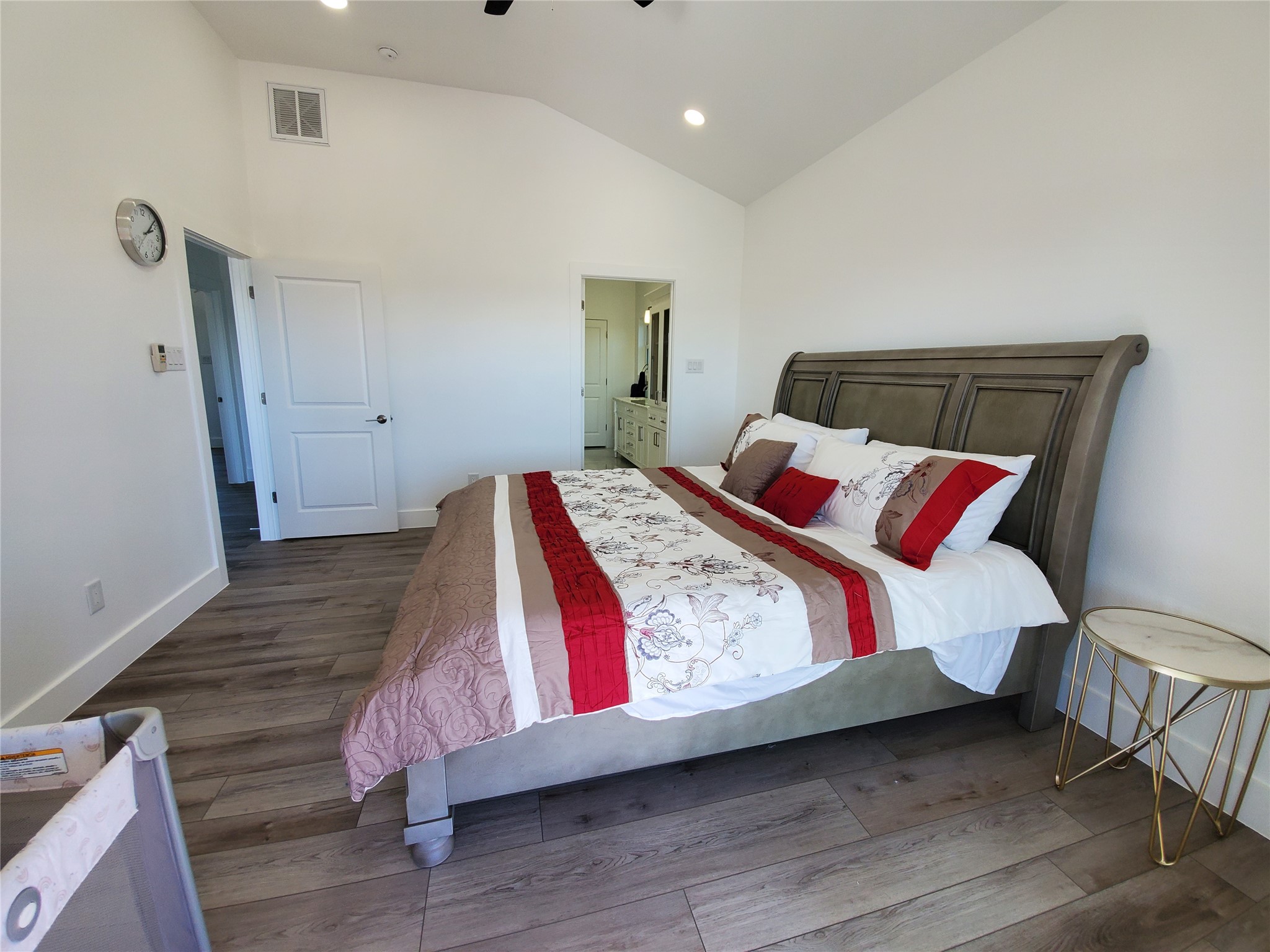 Primary bedroom with vaulted ceilings.
