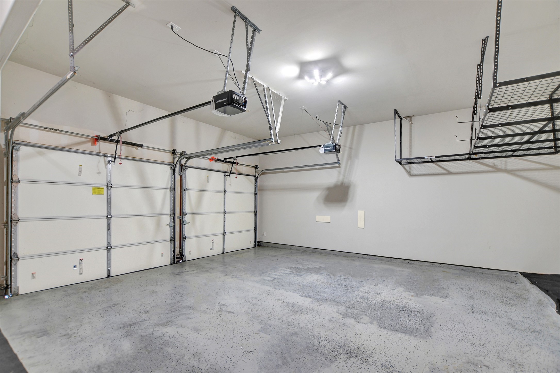 2.5 garage with storage racks and epoxy flooring.