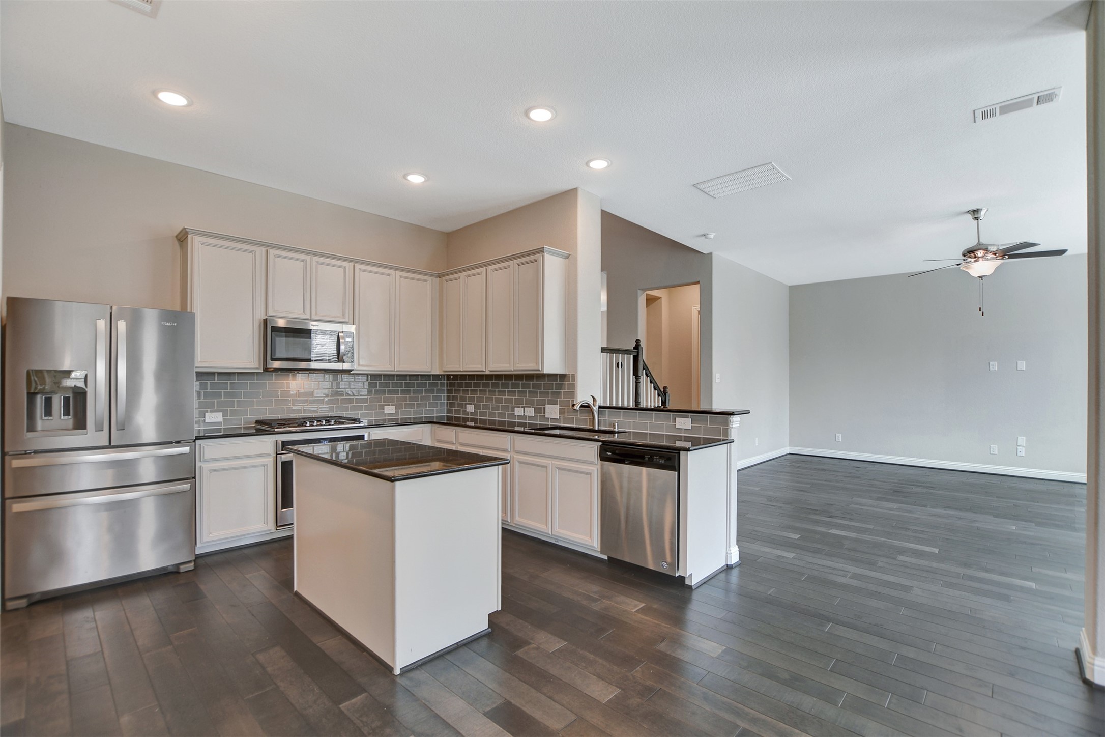 Gourmet granite island kitchen with SS built-in appliances and breakfast nook.
