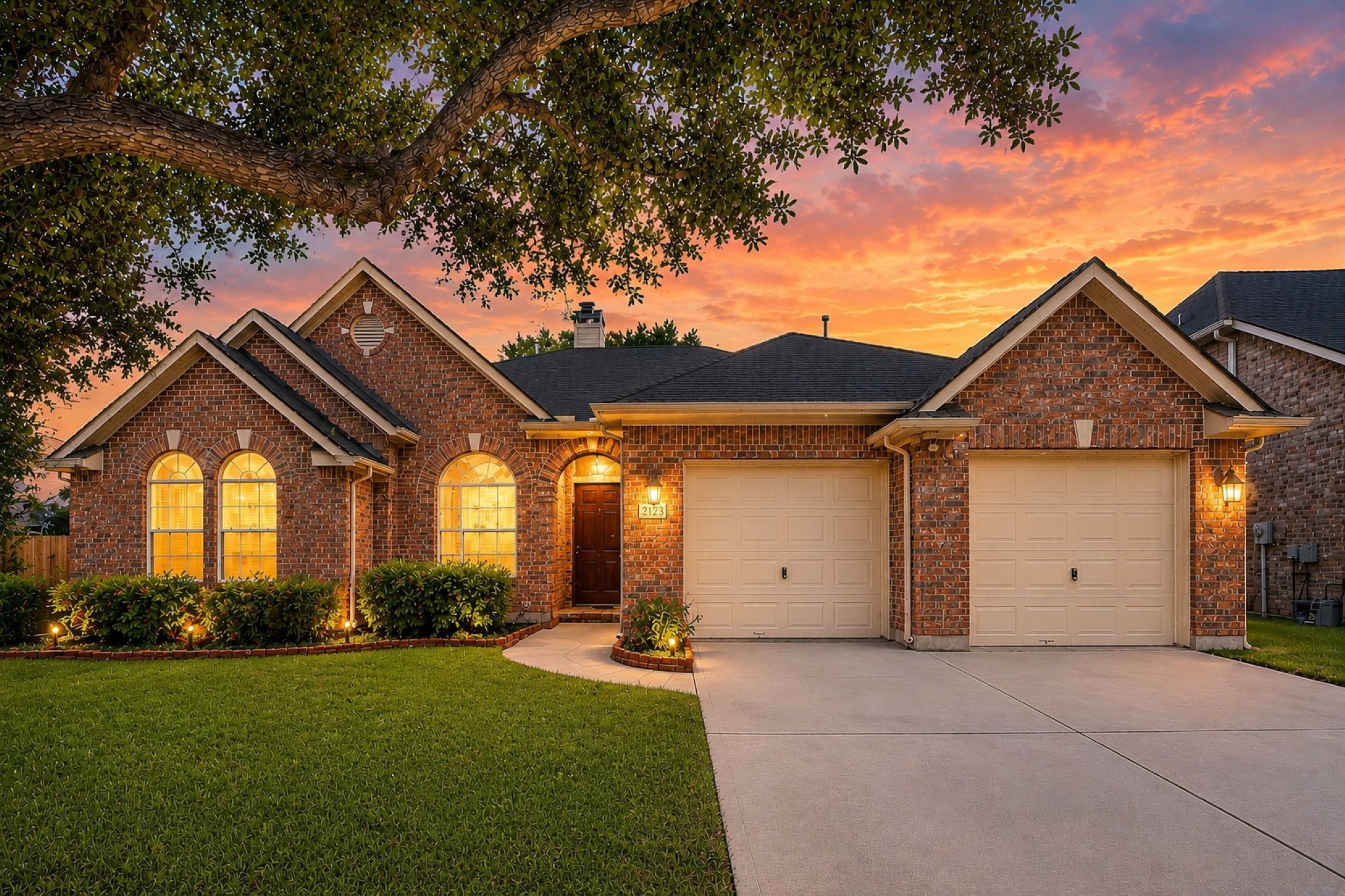 VIRTUALLY STAGED!
This charming brick home features a well-maintained lawn, a two-car garage, and warmly lit arched windows. The sunset backdrop and mature tree add to the inviting curb appeal. VIRTUALLY STAGED!
This charming brick home features a well-maintained lawn, a two-car garage, and warmly lit arched windows. The sunset backdrop and mature tree add to the inviting curb appeal.