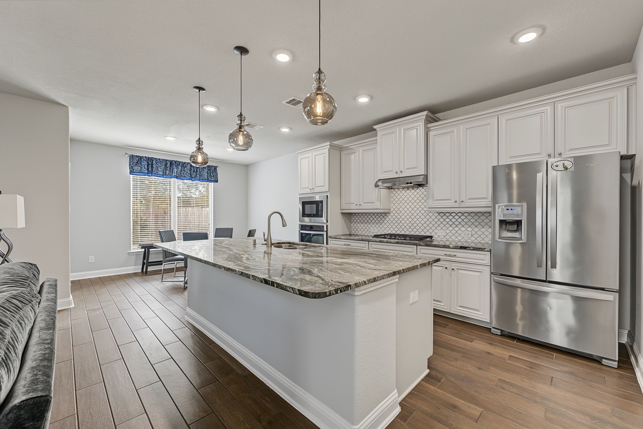 The well appointed kitchen features stunning granite counters, plenty of storage and a large walk in pantry. The fridge can stay! The well appointed kitchen features stunning granite counters, plenty of storage and a large walk in pantry. The fridge can stay!