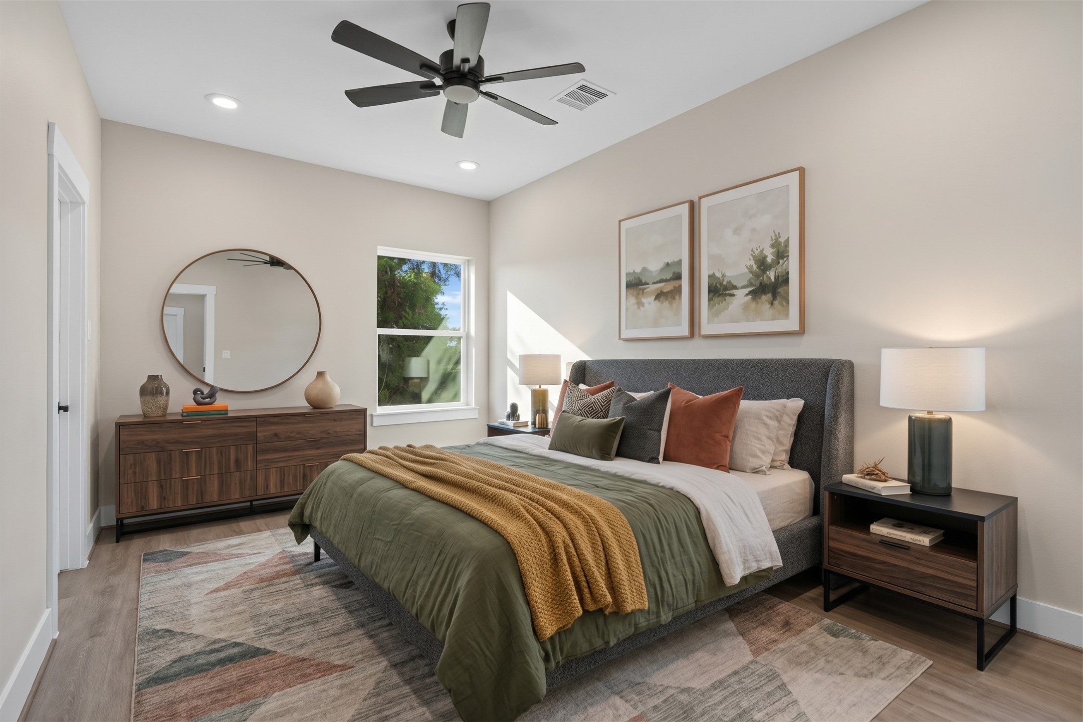 Virtually Staged: This cozy secondary bedroom offers a bright layout with high ceilings, recessed lighting, and a modern ceiling fan. A large side window fills the room with natural light, while the versatile floor plan easily accommodates full bedroom furniture