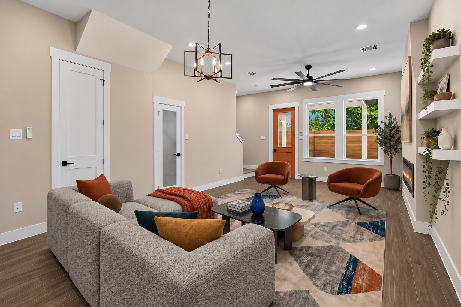Virtually Staged: Large windows bring in abundant natural daylight, while floating wall shelves and an integrated fireplace elevate the overall aesthetic.