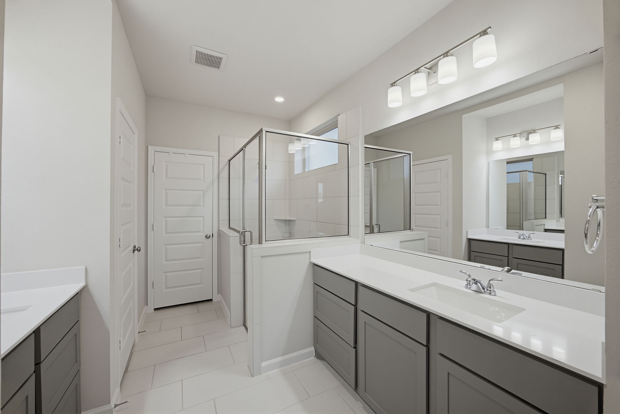 En-suite primary bath with large tub and walk-in shower