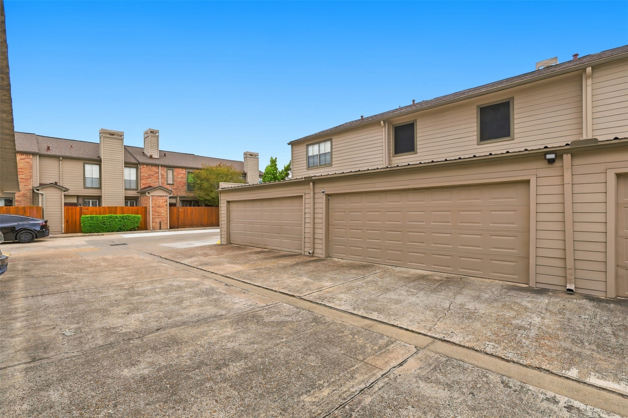 Spacious two-car garage with a paved driveway offers ample parking and easy access to the home.