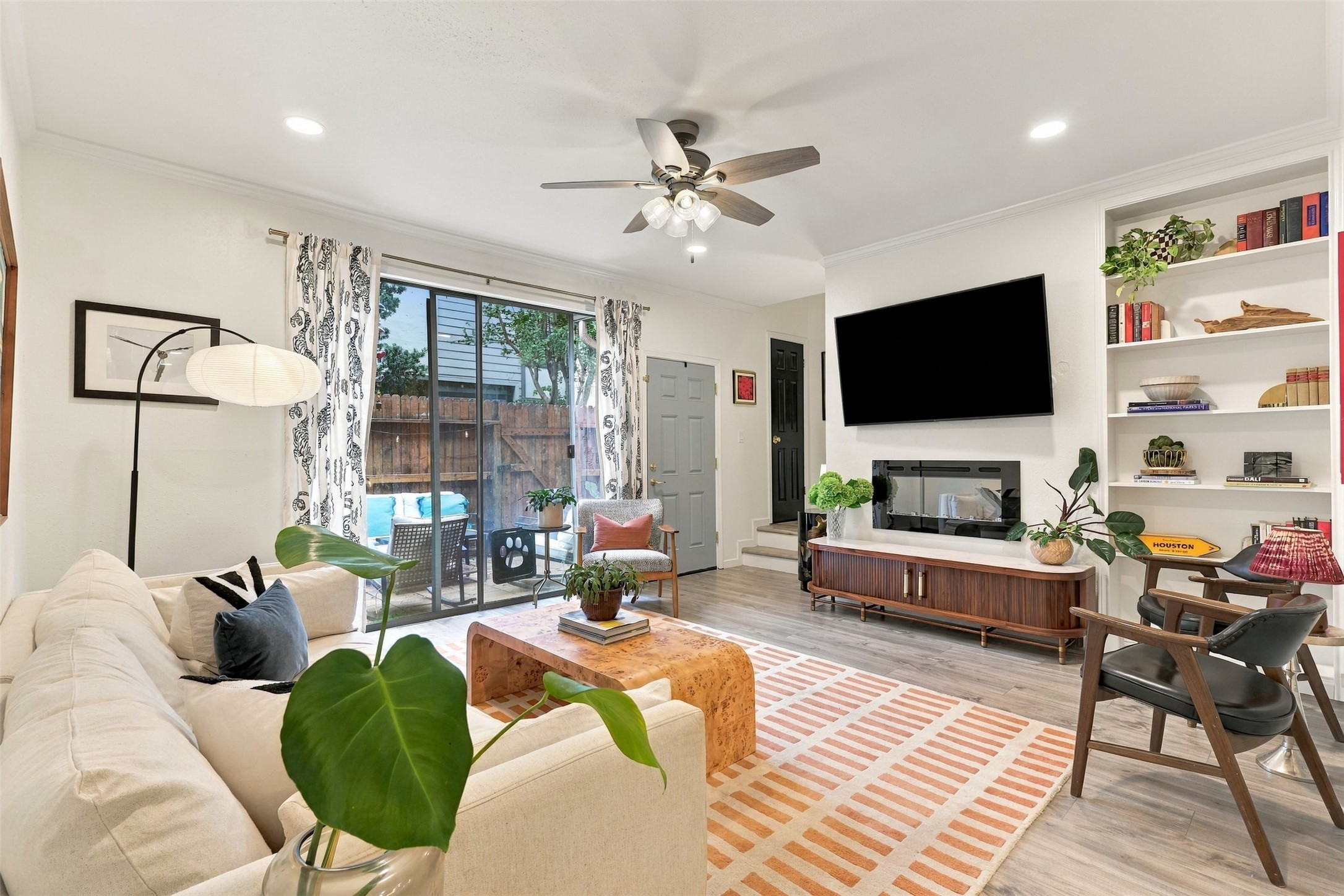 Sliding glass doors bring daylight into the living room and lead directly to the enclosed patio.