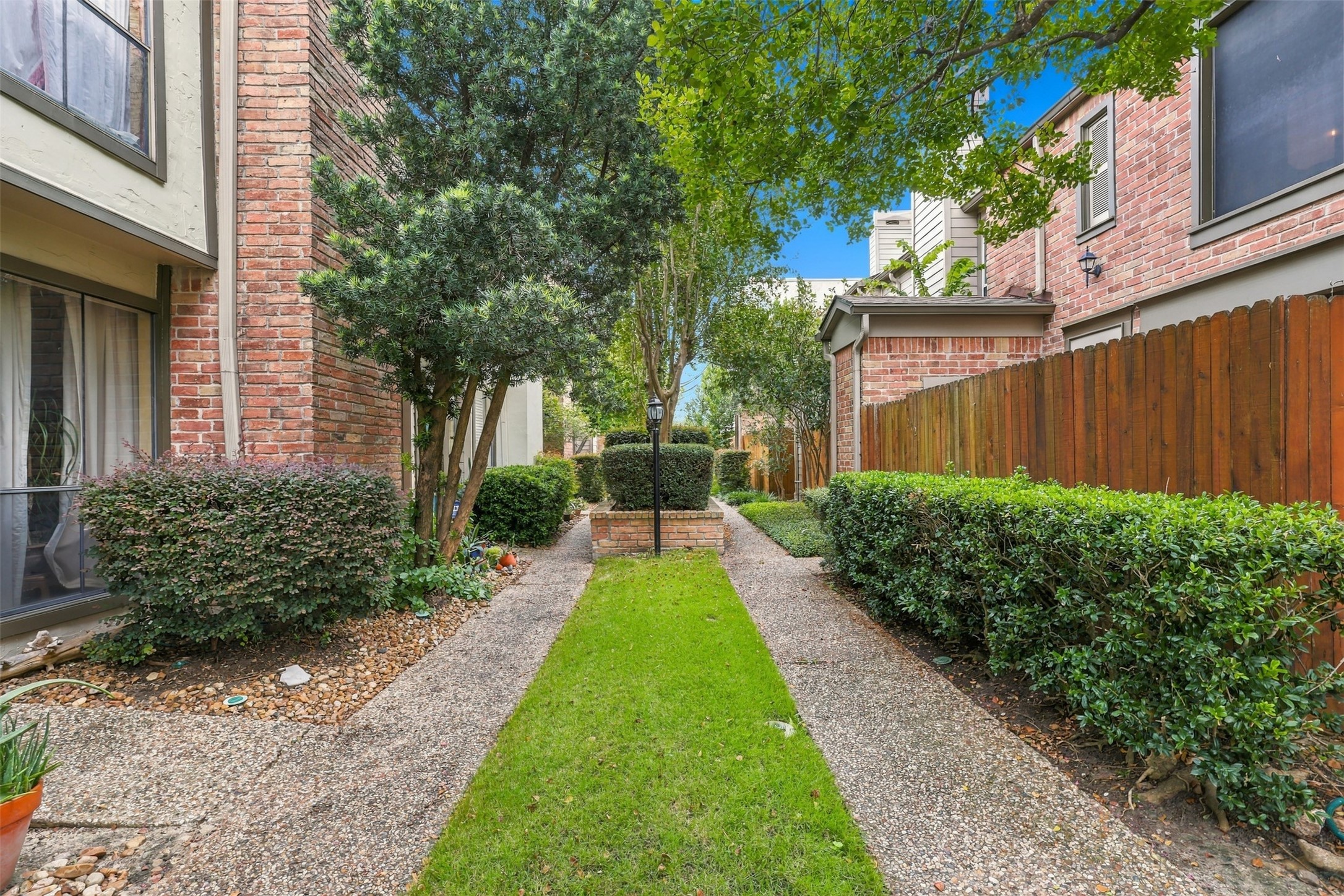 Landscaped paths and mature greenery create a welcoming approach to the residence.