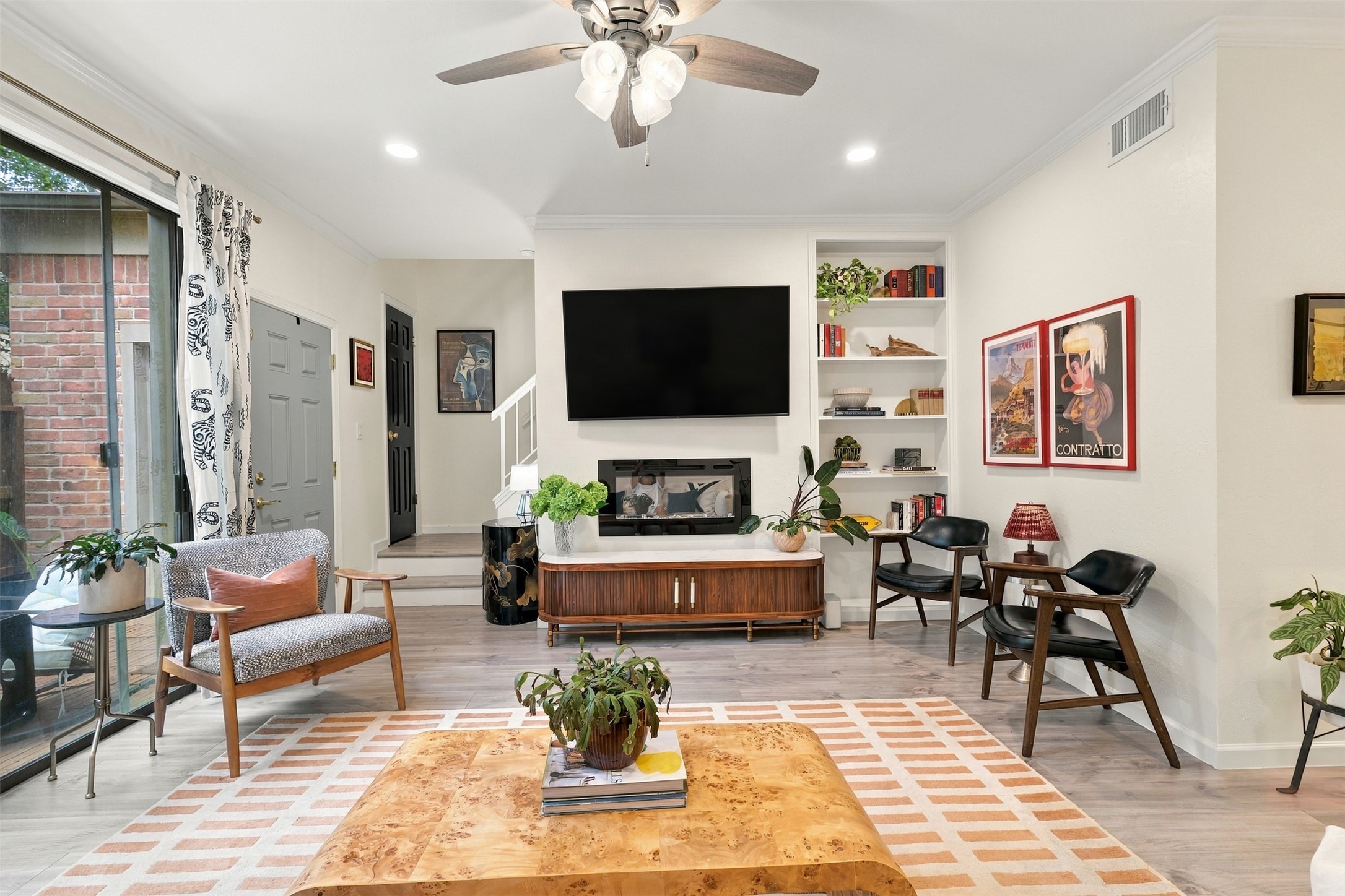 An electric fireplace anchors the living area, with patio access just steps away.