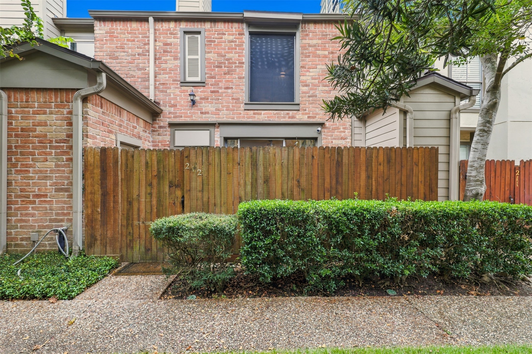 The fenced courtyard offers a sense of privacy before you even step inside.