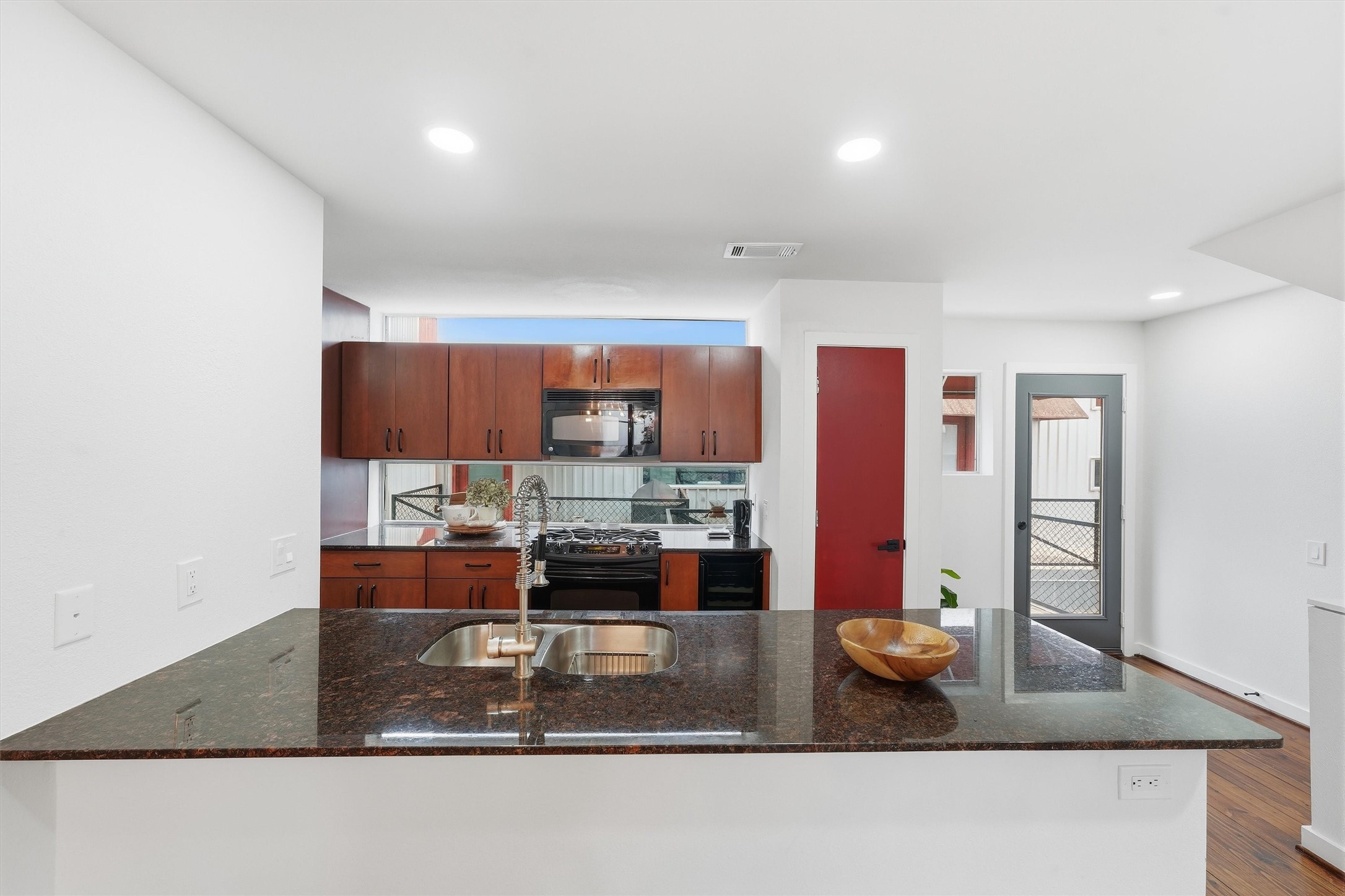 Counter height bar. Coat closet. The door at the top of the stairs to the balcony.