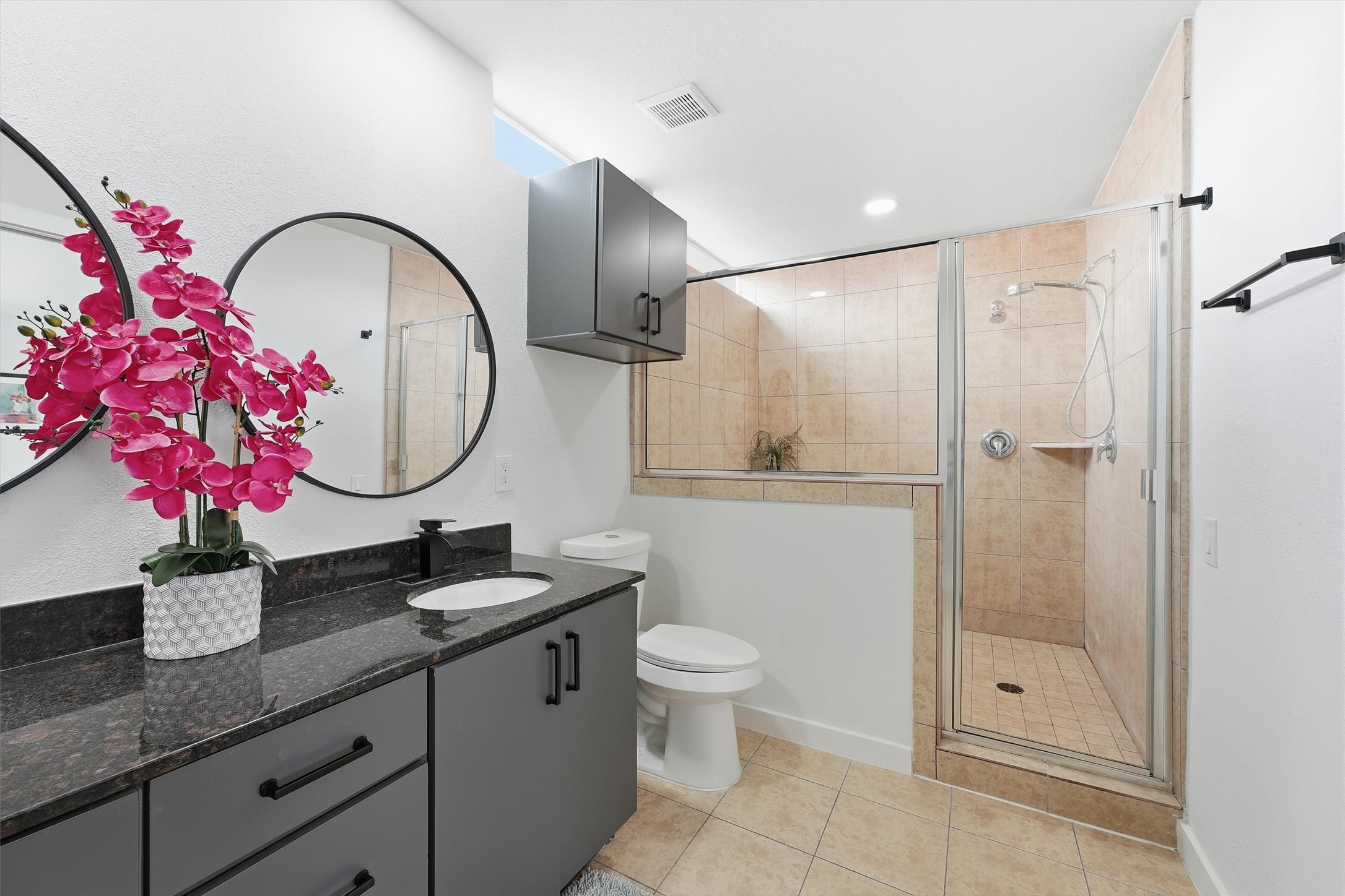 Primary bathroom features double-sinks, soaking tub and separate shower, and low flow toilet.