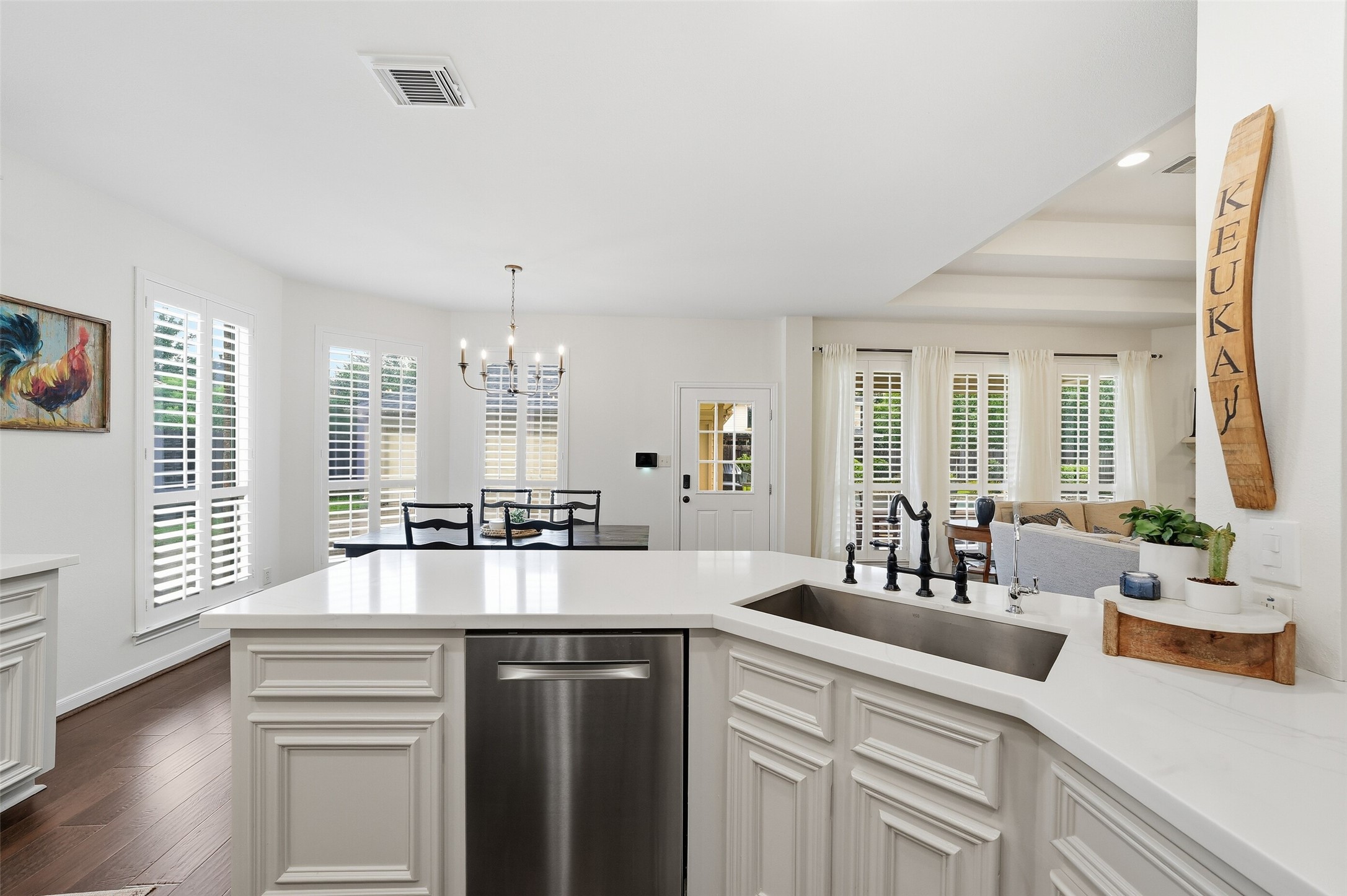 The beautifully renovated kitchen includes quartz countertops, stainless steel appliances and a large farmhouse style sink.