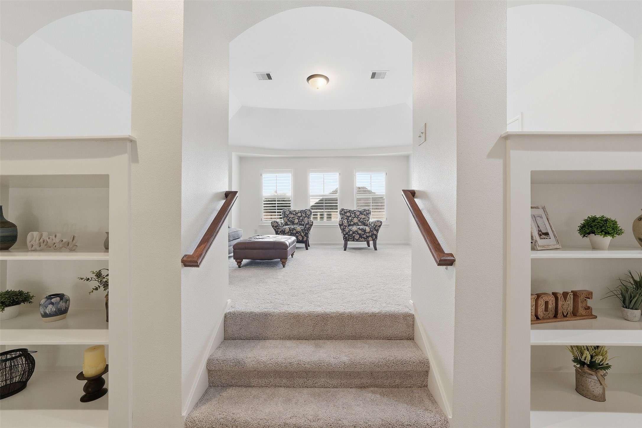 Built-in book shelves flank the steps into the gameroom.