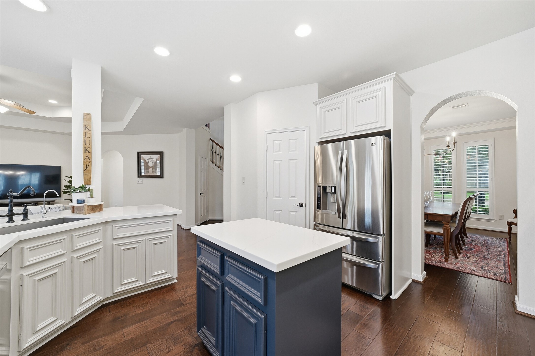 The walk-in pantry is to the left of the refrigerator.