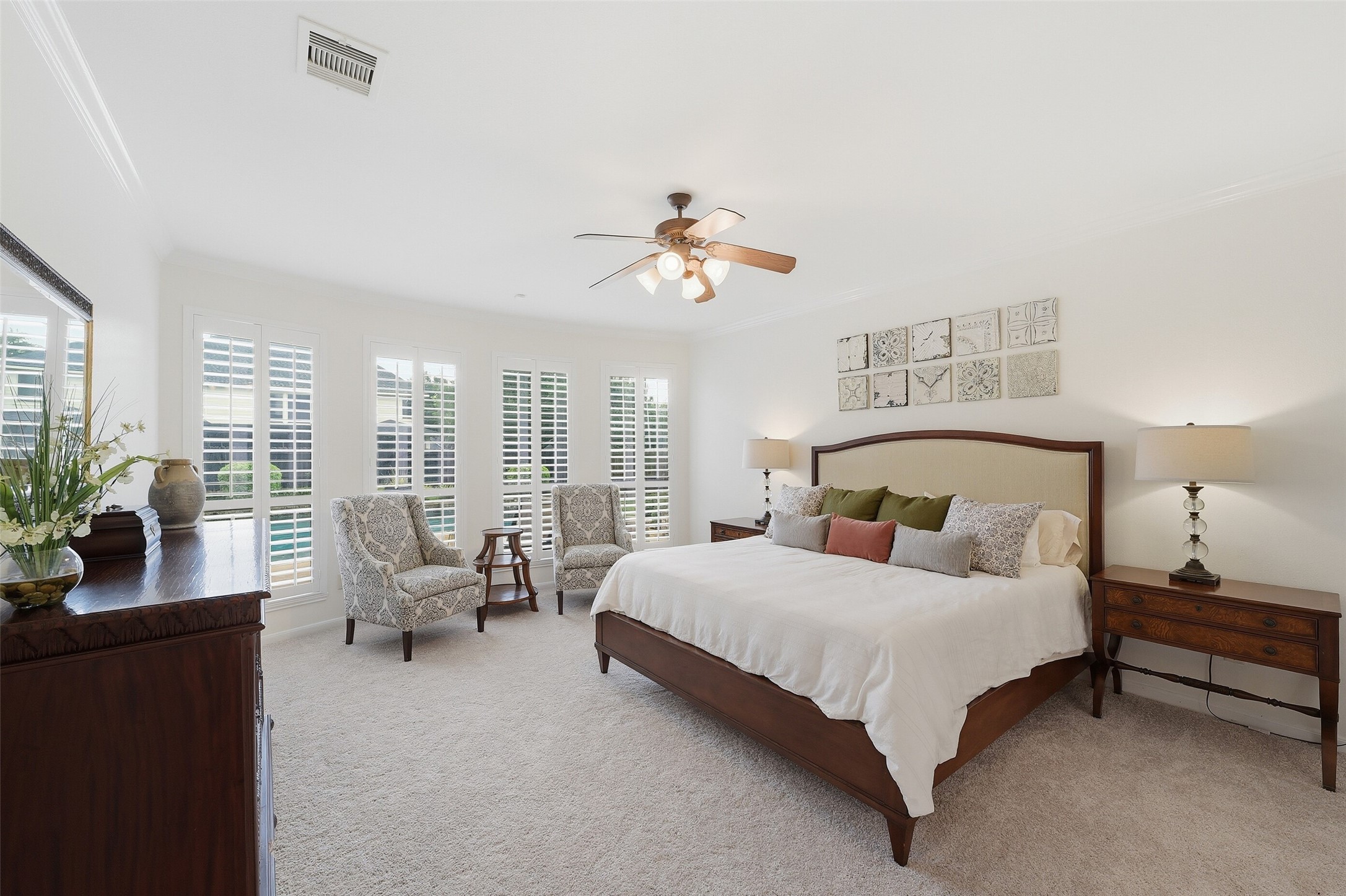 The primary bedroom sits in the rear of the home with a view of the sparkling pool.