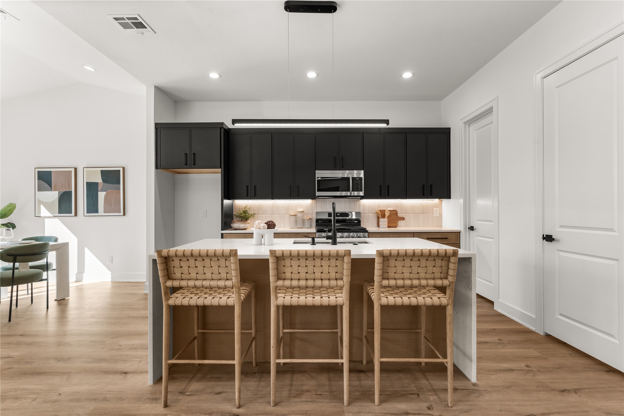 Positioned between the living and dining areas, the kitchen encourages effortless interaction while keeping everyday essentials within easy reach.