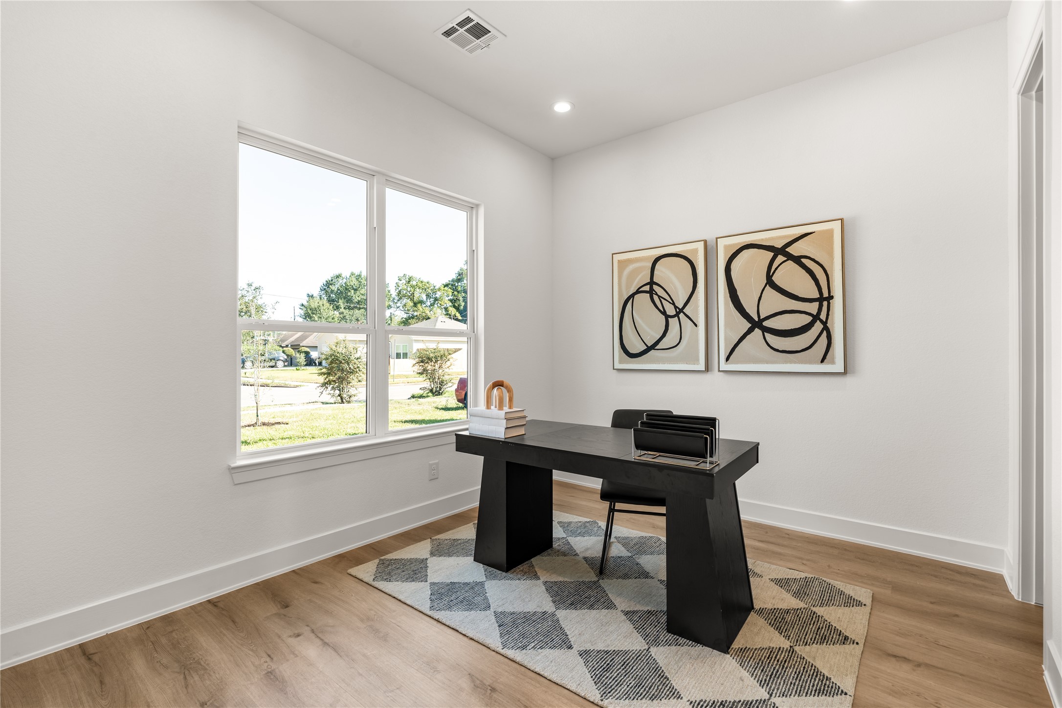Expansive front-facing windows illuminate thoughtfully positioned office / bedroom near the entry, the room offers privacy without sacrificing its connection to the home.