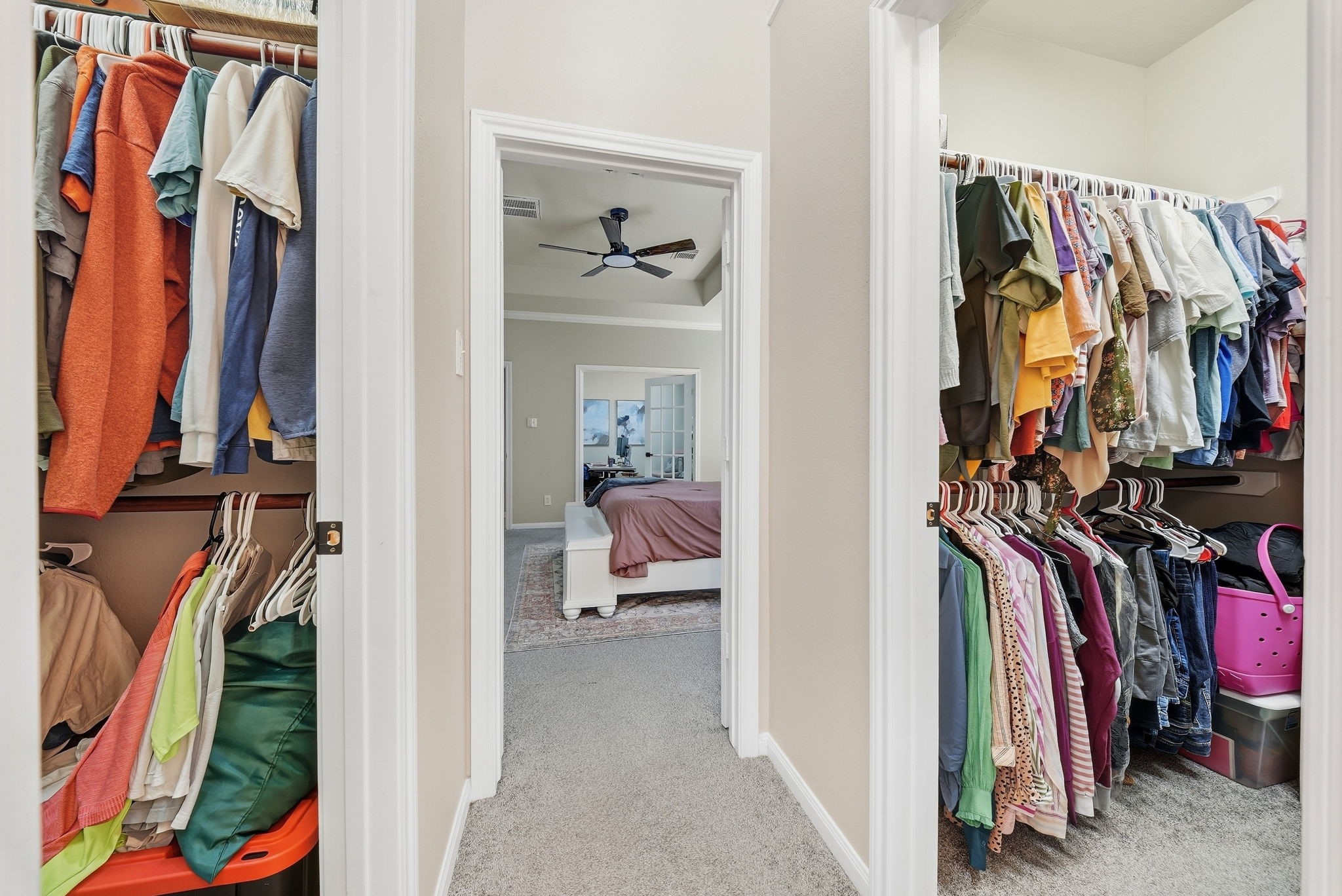 Spacious walk-in closets with extensive hanging and storage space connecting to the primary bedroom.