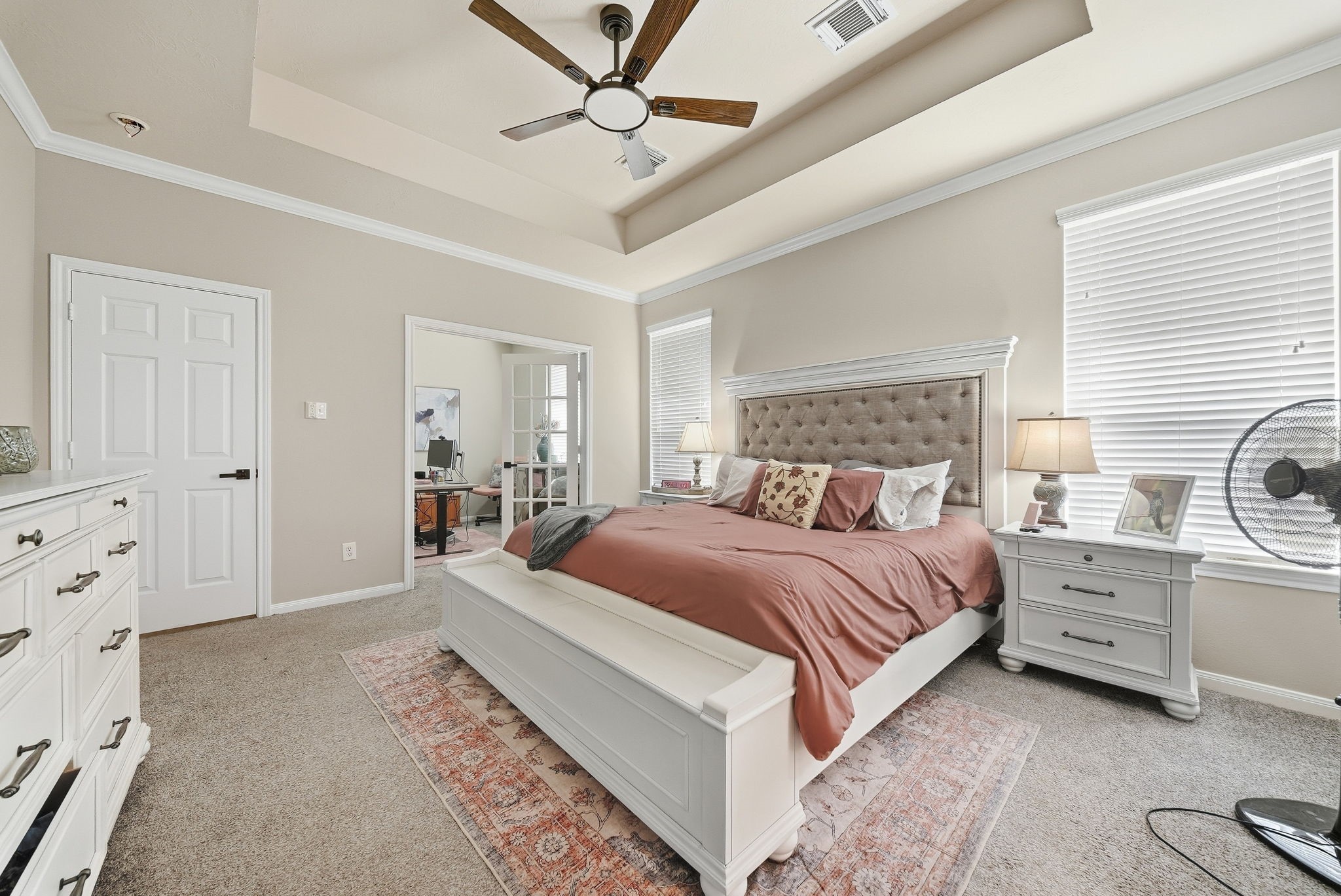 The primary bedroom offers a functional, bright office space.