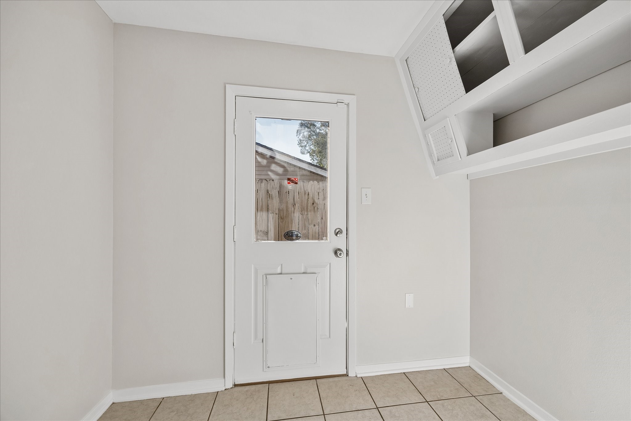 The mud room leading to the backyard has some storage space and room for a fridge or deep freeze.