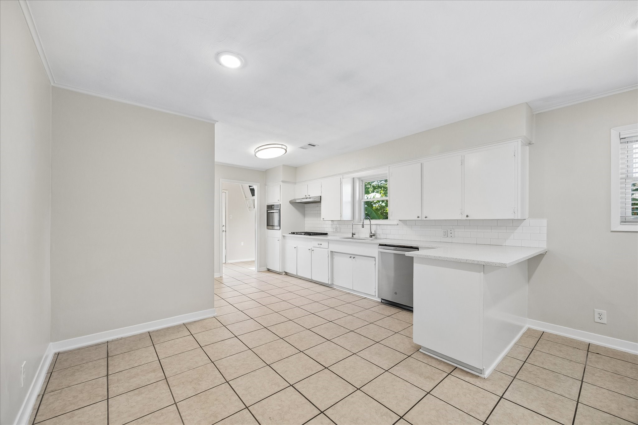 The kitchen has been updated with quartz countertops, freshly painted cabinets and stainless appliances. Lots of room to enjoy family or company while cooking.