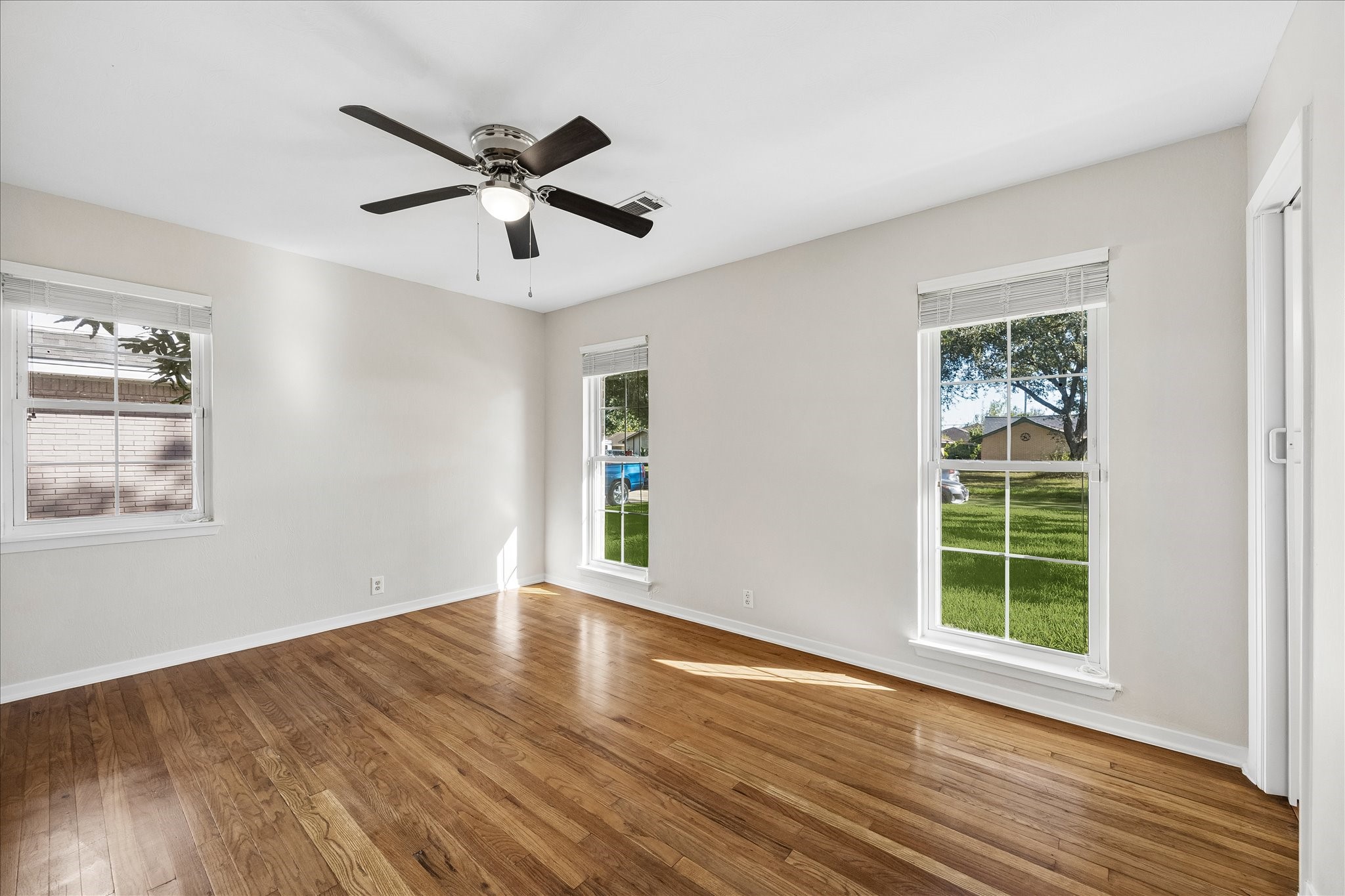 The primary bedroom features wood floors and lovely windows that allow for natural lighting. The primary bedroom features wood floors and lovely windows that allow for natural lighting.