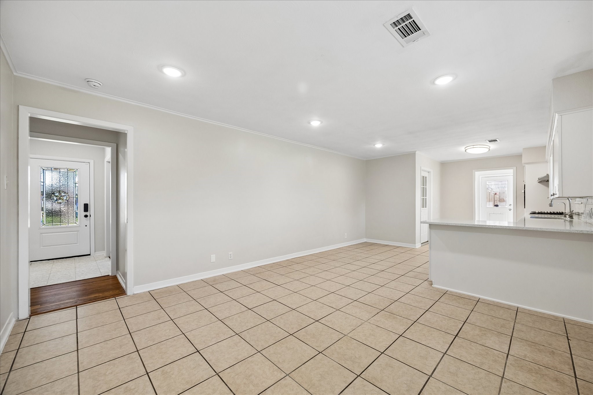 A view to the front door from the kitchen/dining area. Lots of potential to make this space your own.