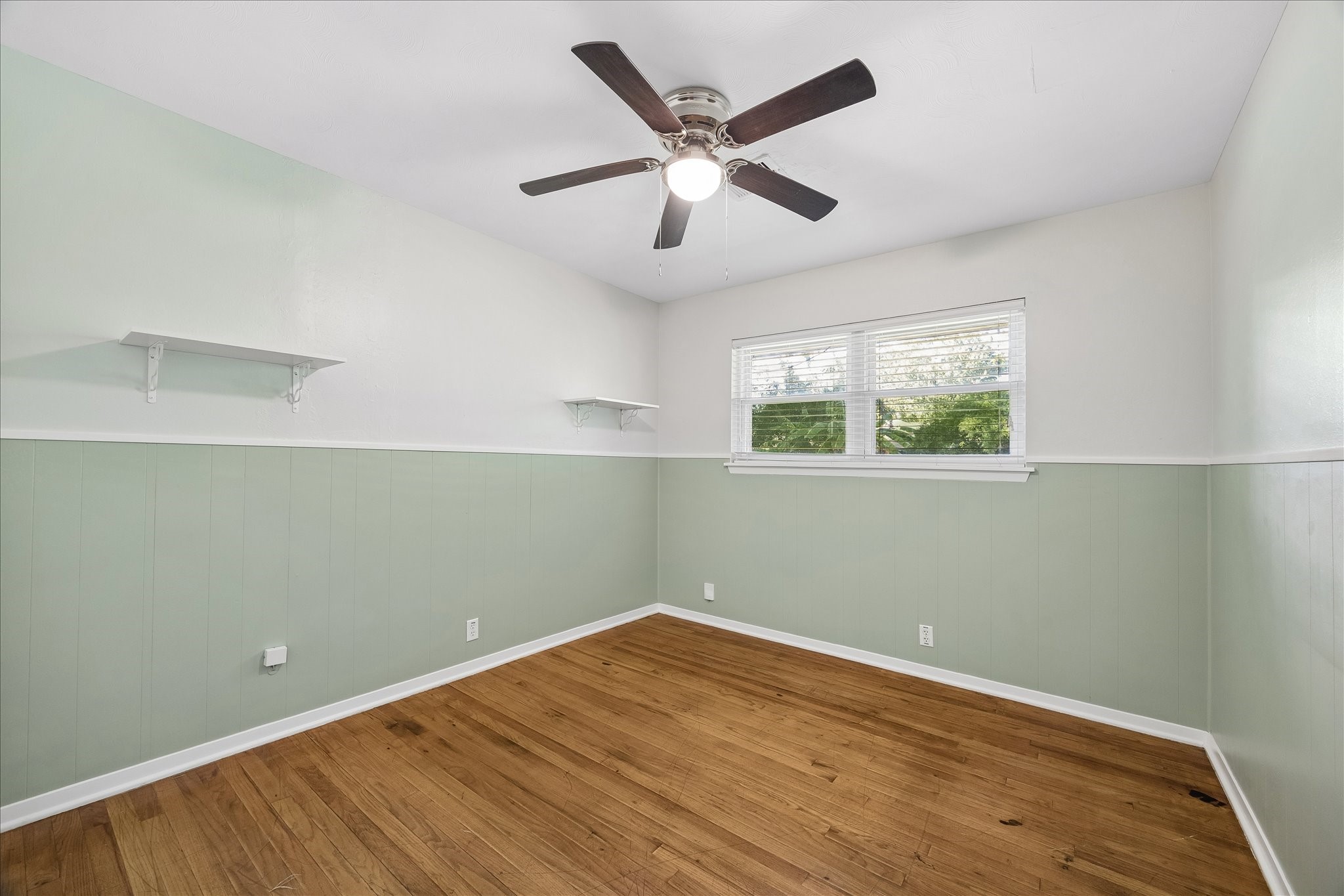 Bedroom 3 has a light paint and wood floors.