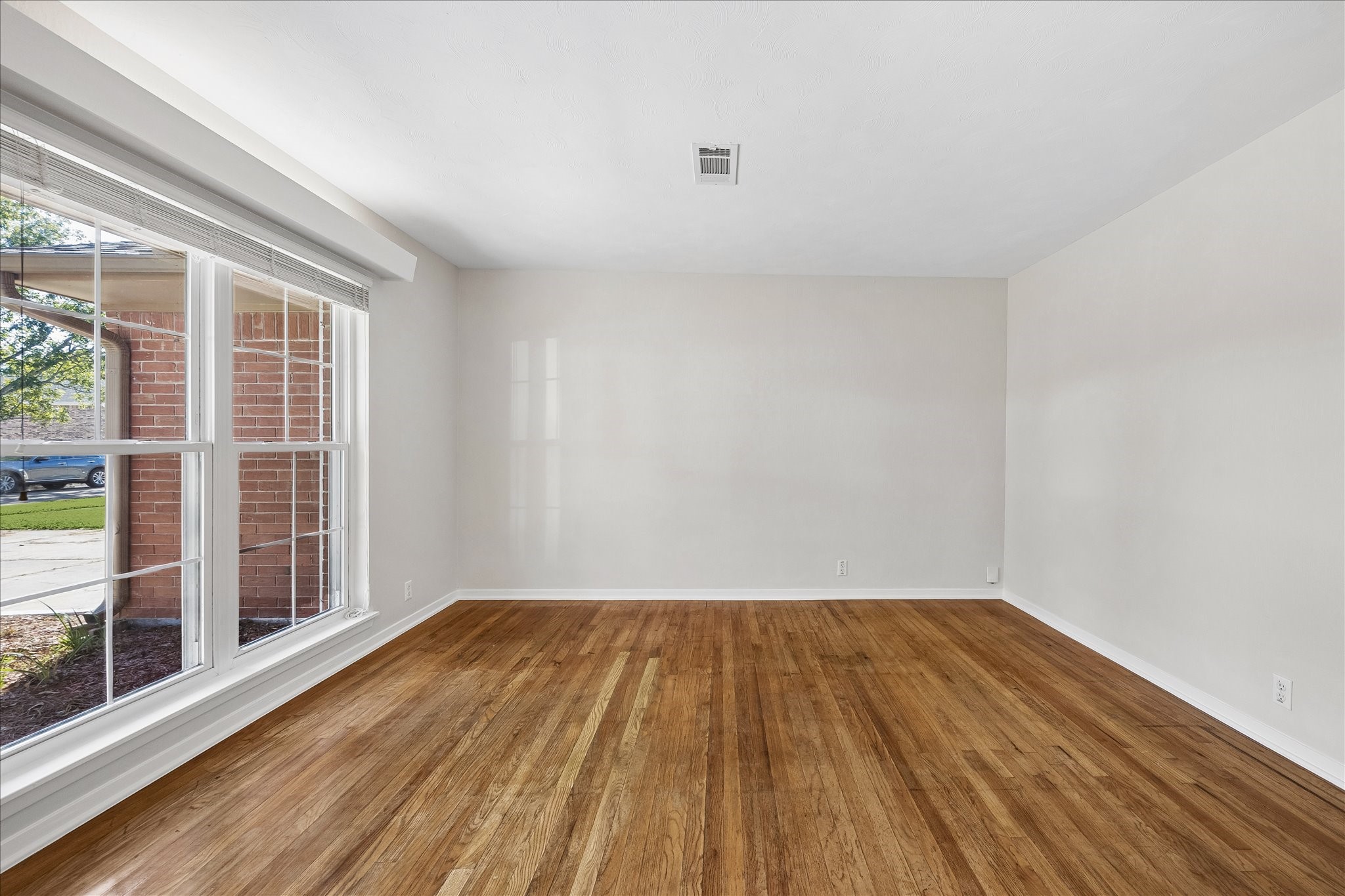 This room features hardwood floors and windows that let in natural light. This room features hardwood floors and windows that let in natural light.