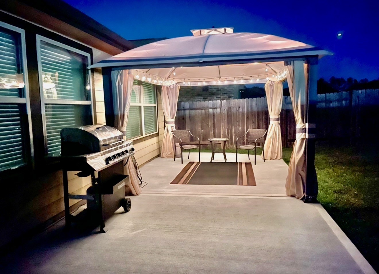 Discover the perfect retreat with a spacious back patio featuring a charming gazebo, cozy seating, and a sleek grill for seamless outdoor entertaining.