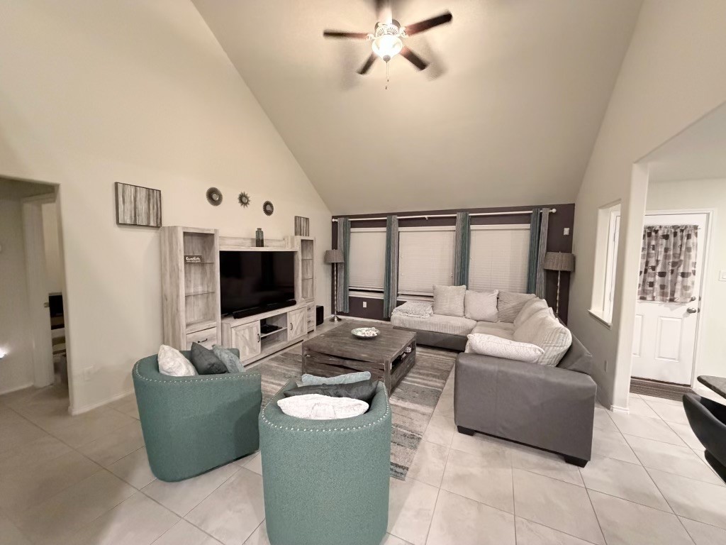 Unwind in this inviting living space, featuring high ceilings, cozy seating, and a calming atmosphere perfect for relaxation. Unwind in this inviting living space, featuring high ceilings, cozy seating, and a calming atmosphere perfect for relaxation.
