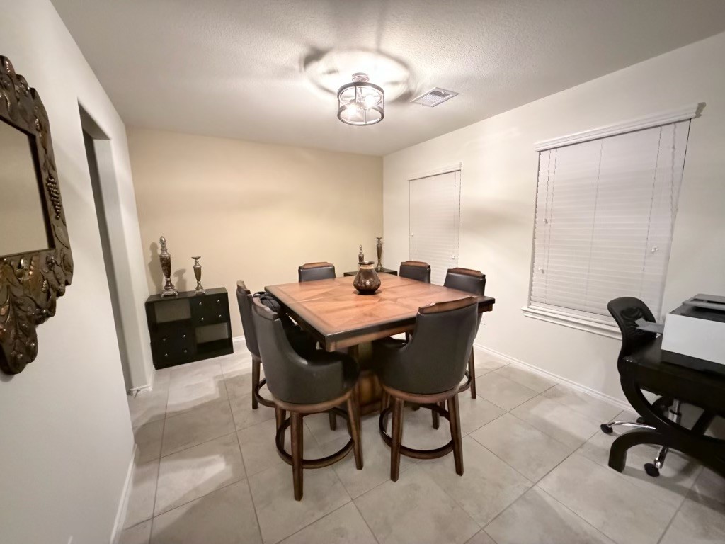 Discover a charming dining area with a warm ambiance, featuring ample natural light to create inviting gatherings. Discover a charming dining area with a warm ambiance, featuring ample natural light to create inviting gatherings.