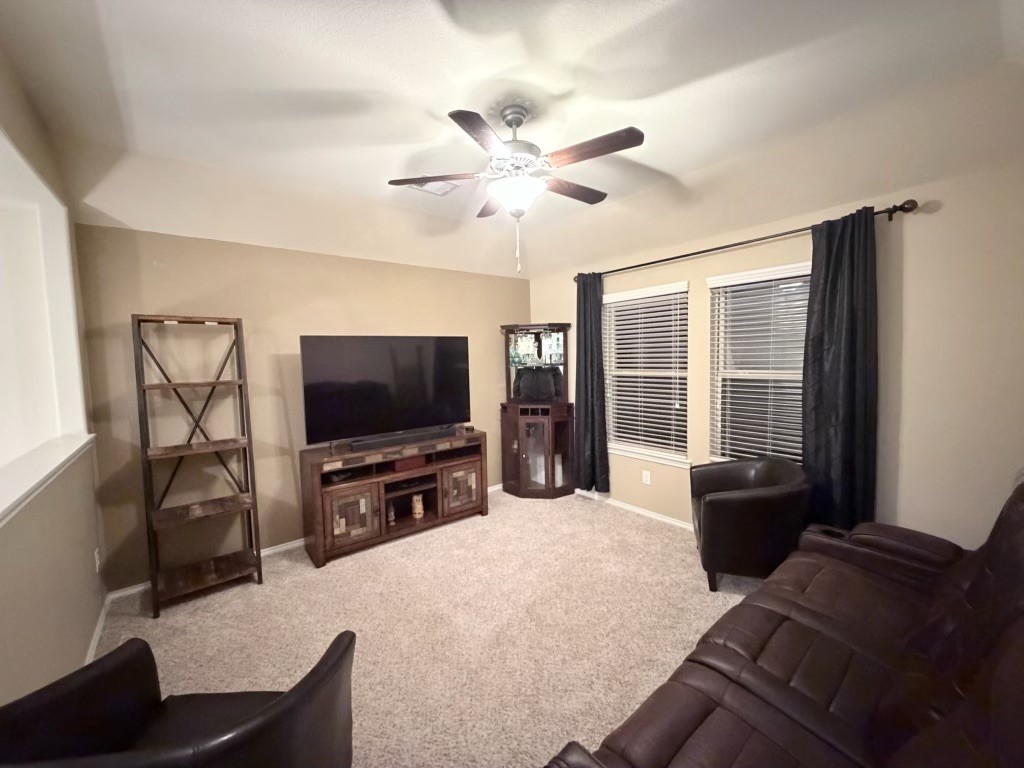 Discover the ultimate retreat in this versatile space, perfect for a man cave, game room, or home office, featuring cozy seating, a large TV, and abundant natural light.