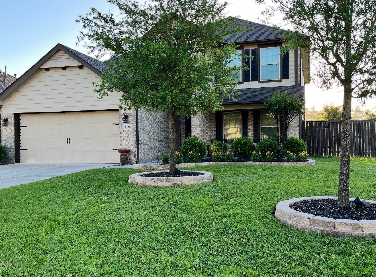 This charming two-story home features a classic brick facade with modern siding, a spacious two-car garage, and a well-maintained front lawn. Mature trees and landscaped shrubbery enhance its curb appeal, while a wooden privacy fence outlines the property. This charming two-story home features a classic brick facade with modern siding, a spacious two-car garage, and a well-maintained front lawn. Mature trees and landscaped shrubbery enhance its curb appeal, while a wooden privacy fence outlines the property.