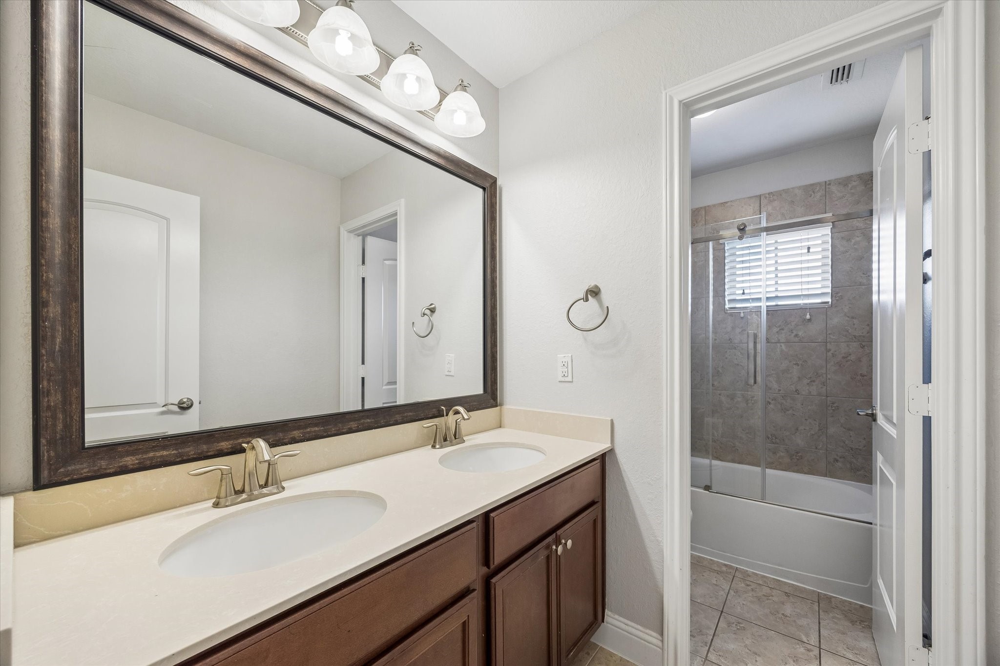 Secondary Bathroom  Well-appointed full bath with modern finishes, double sink and soaking tub