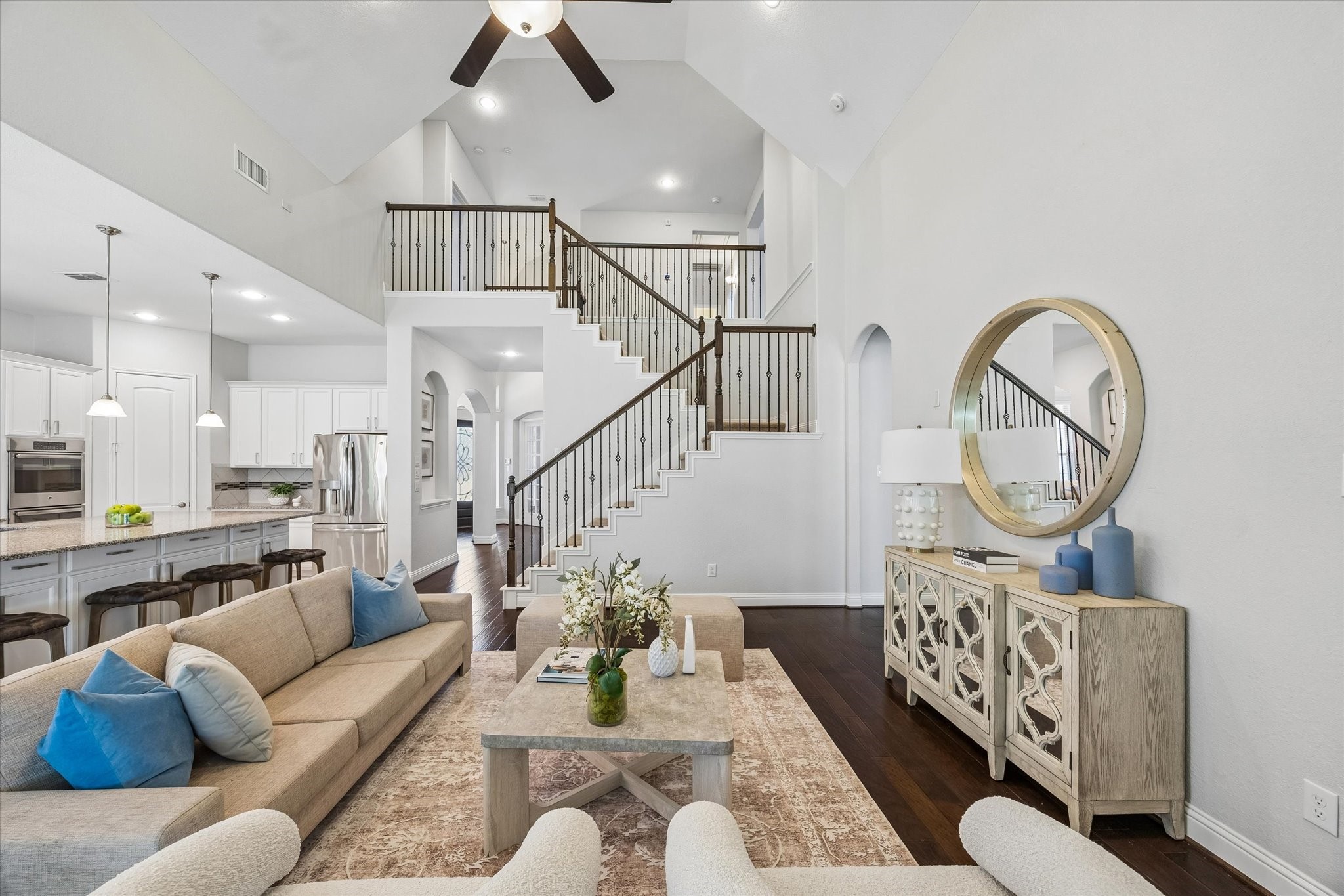 Open-Concept Living Room offers bright and inviting living space with impressive ceiling height Open-Concept Living Room offers bright and inviting living space with impressive ceiling height
