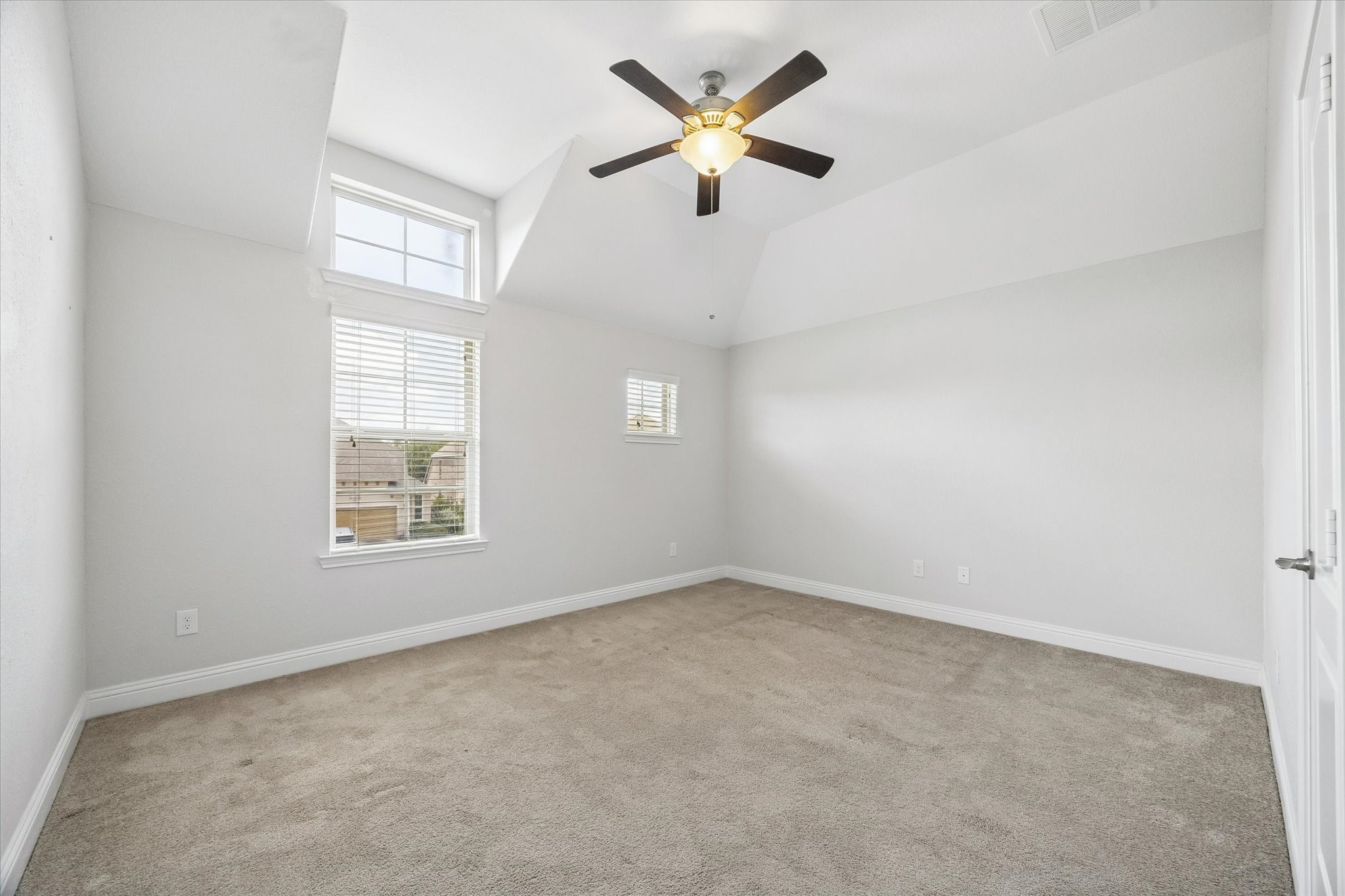 Second Bedroom: Comfortable bedroom with large windows and neutral finishes