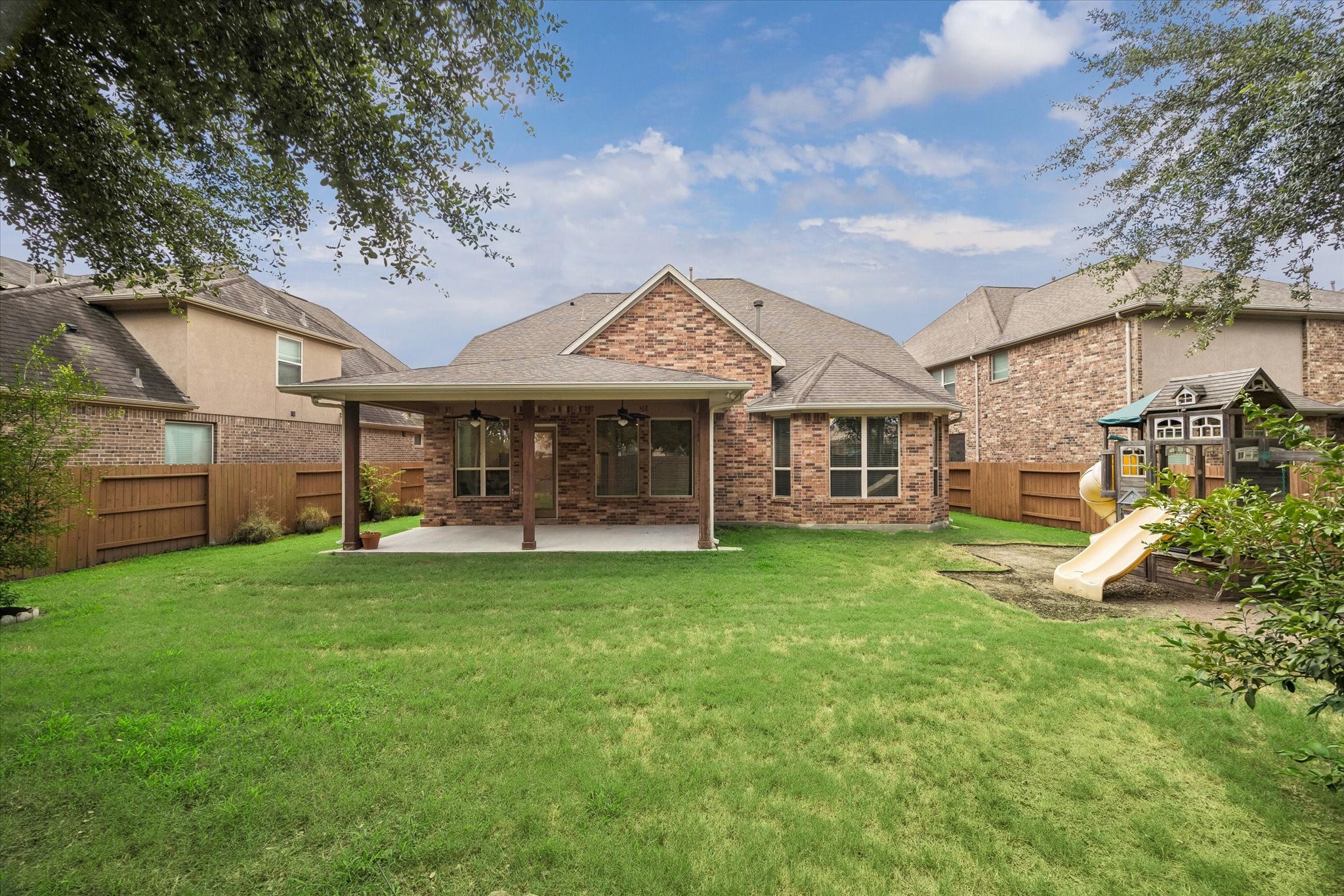 Gorgeous Covered Patio overlooking the spacious backyard with plenty of room for entertaining, play, and Al Fresco dining!