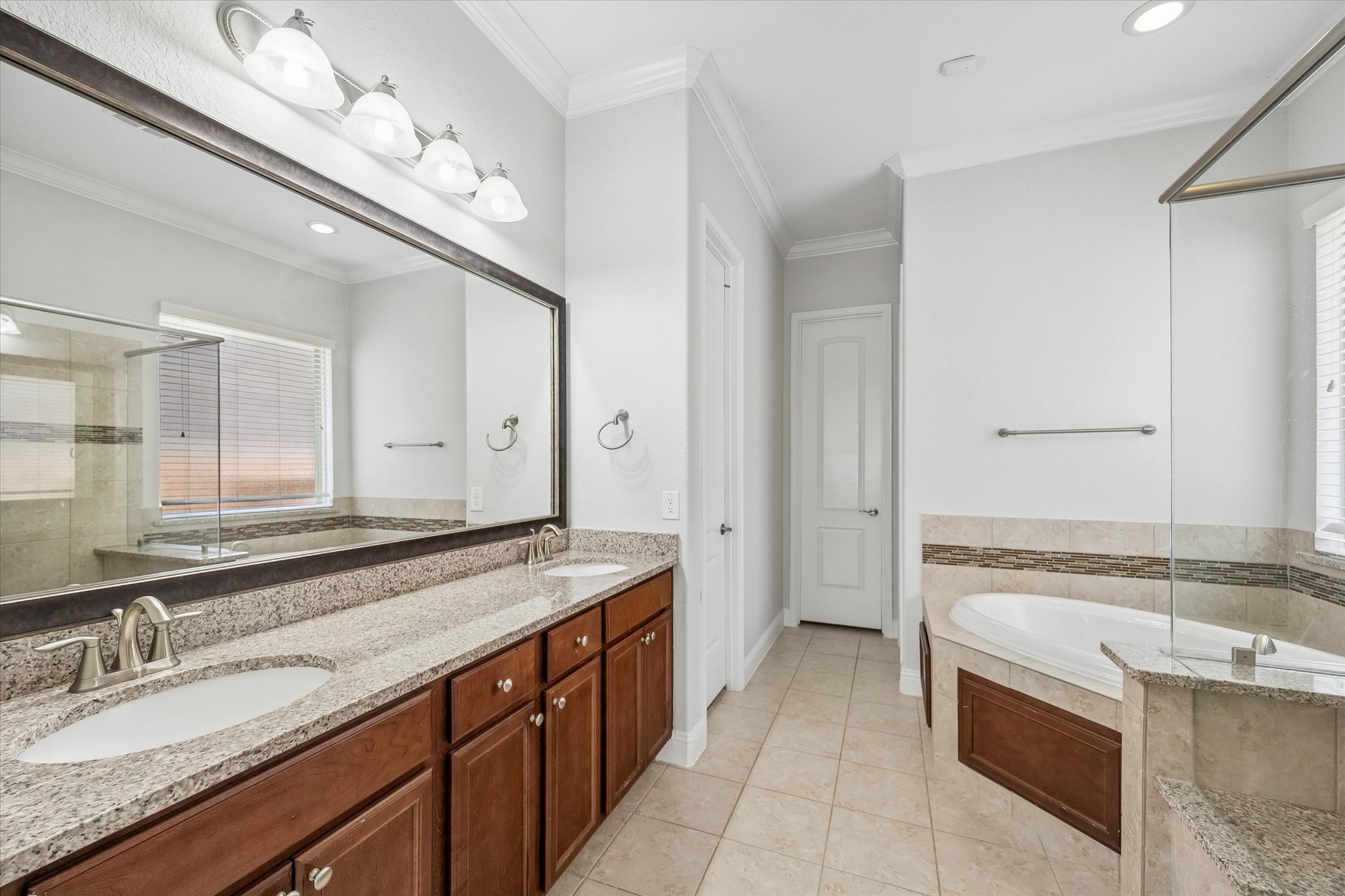 Primary Bathroom with double vanities, soaking tub, and separate shower create a spa-like retreat