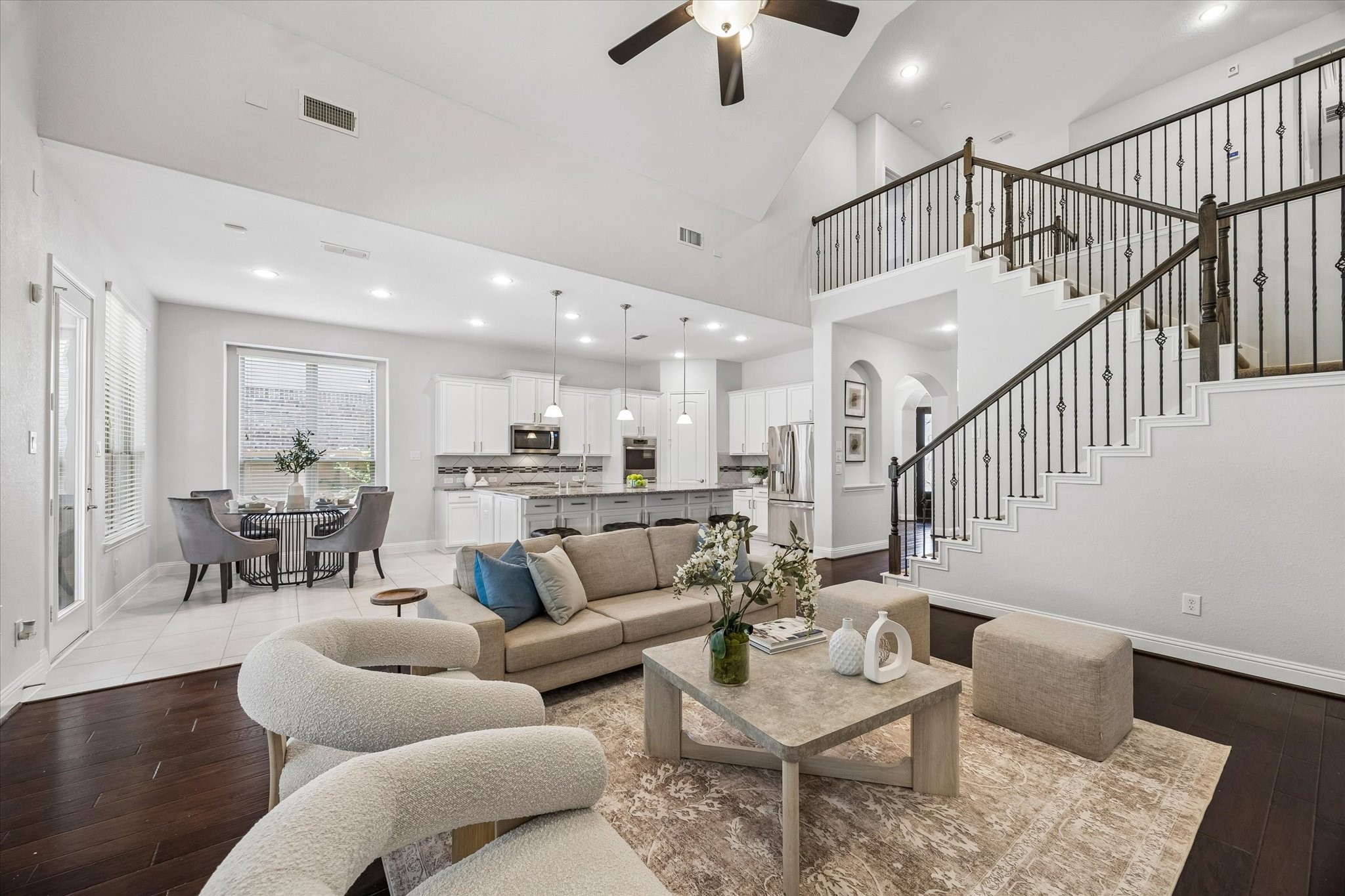 Elegant living room featuring soaring ceilings and rich wood flooring Elegant living room featuring soaring ceilings and rich wood flooring