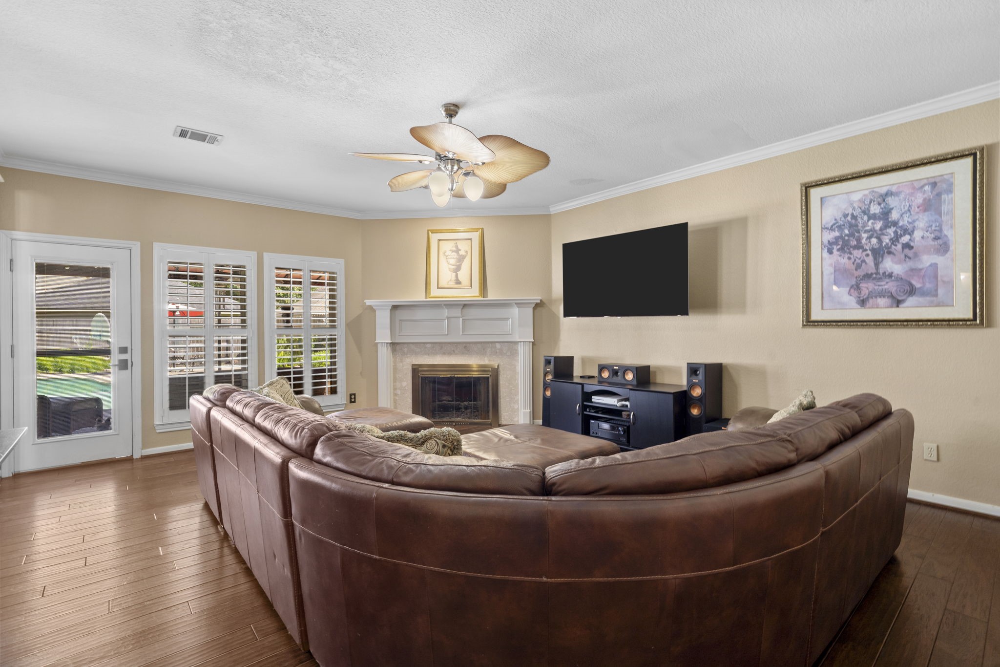 Relax in the family room and enjoy views of the TV, cozy fireplace, or sparkling pool, all from the comfort of this inviting central space.