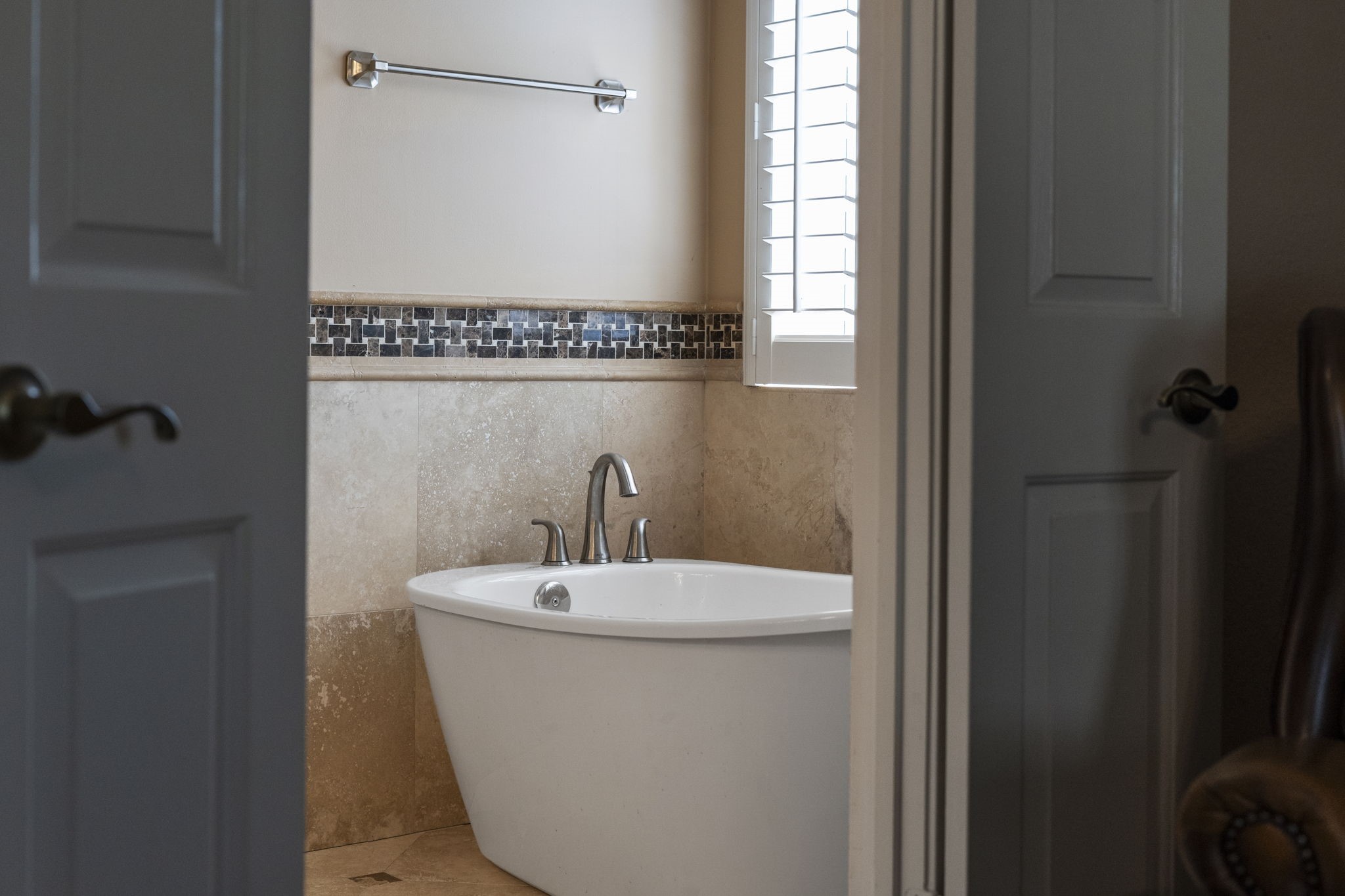 Step inside the beautifully renovated owners bath, featuring a freestanding soaking tub that creates a serene retreat for relaxation.