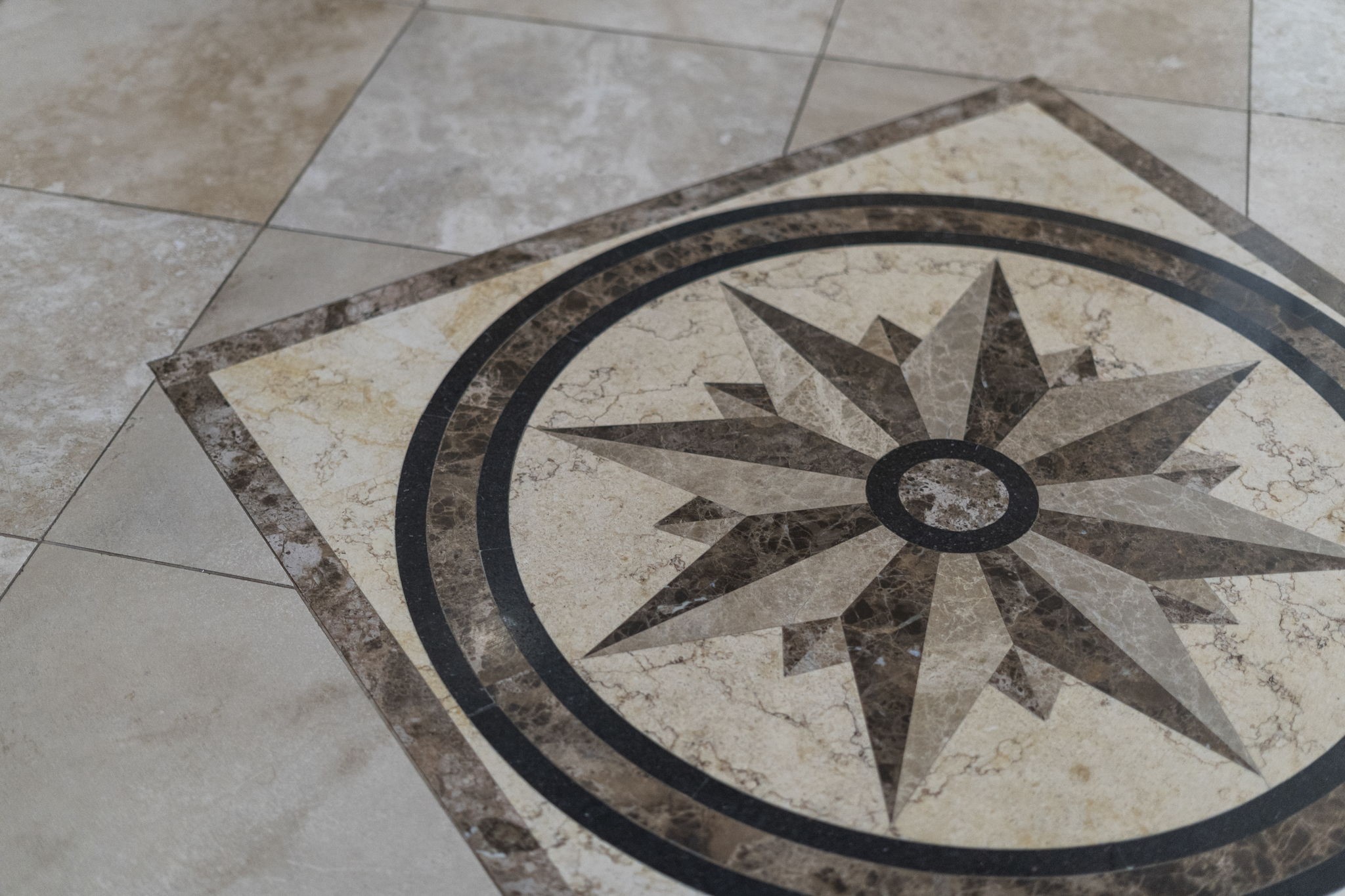 A nautical compass rose mosaic tile inlay creates a striking and memorable statement in the home's entryway, setting a stylish tone from the moment you step inside.
