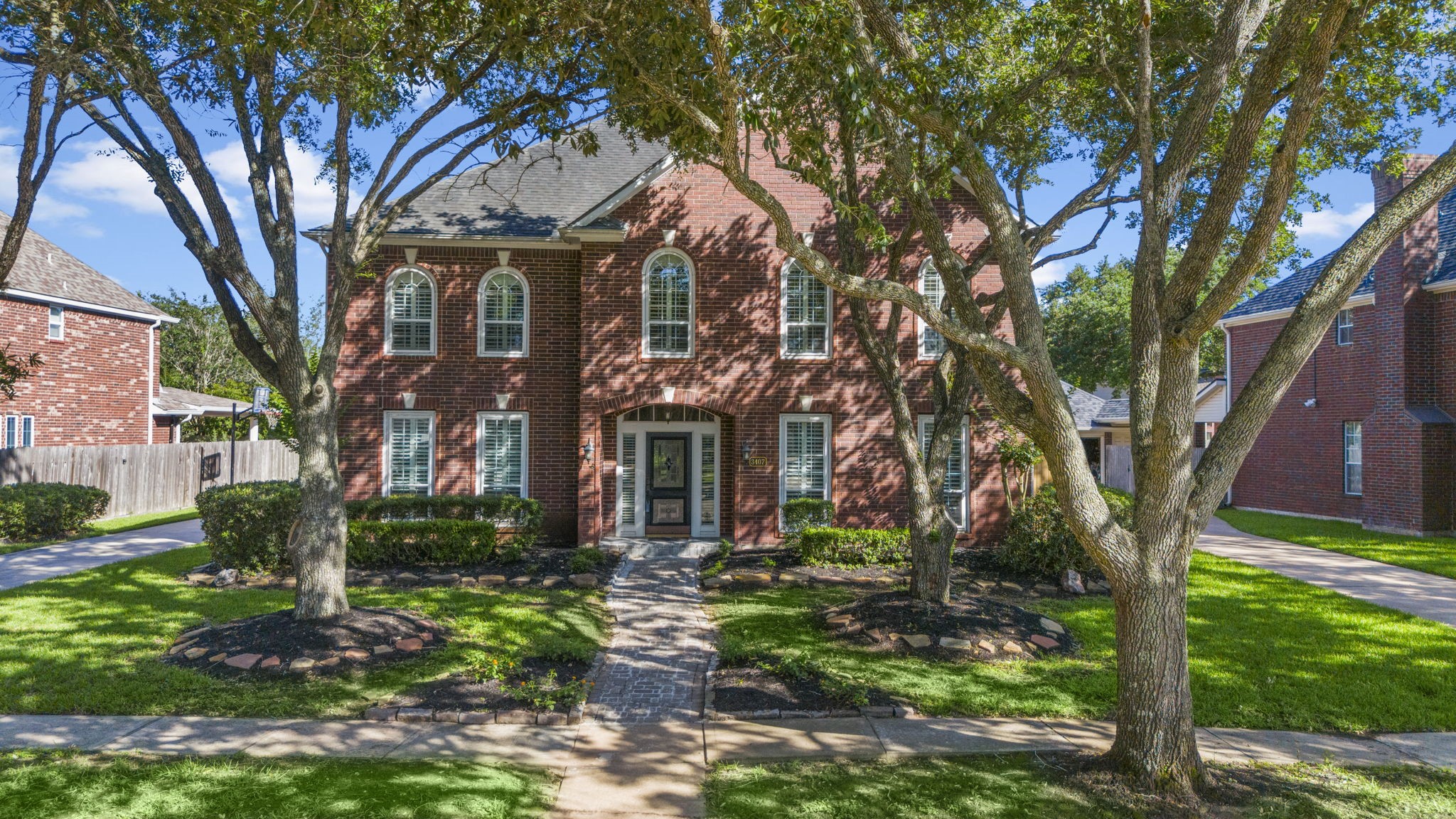Nestled in the heart of Sugar Lands desirable Austin Meadows neighborhood, this well-built Newmark Homes brick two-story offers timeless curb appeal, spacious living, and a warm, inviting atmosphere.