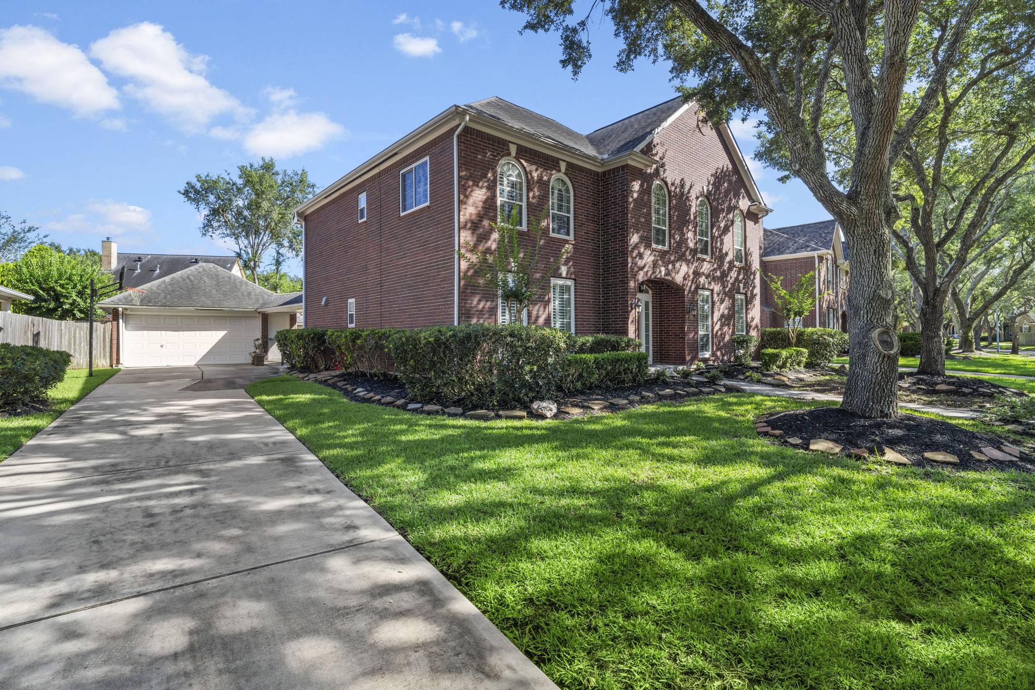 A long driveway leads to a detached two-car garage, offering ample off-street parking and plenty of space for recreationperfect for basketball, bike riding, or kids playing safely right at home.