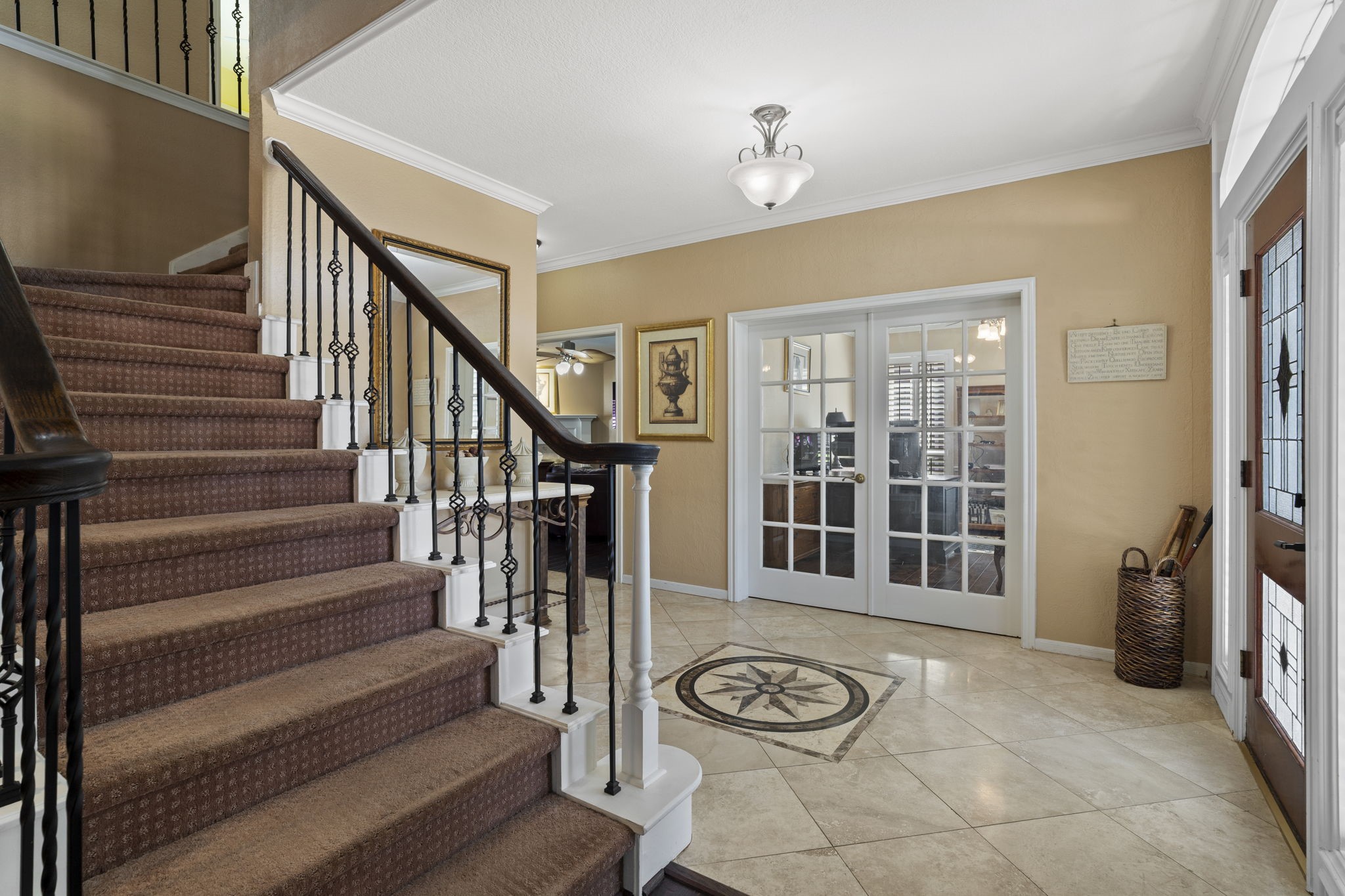 The home office is conveniently located just as you enter the home, offering easy access while maintaining a sense of separation. Elegant French doors provide added privacy, making it an ideal space for focused work or quiet study.